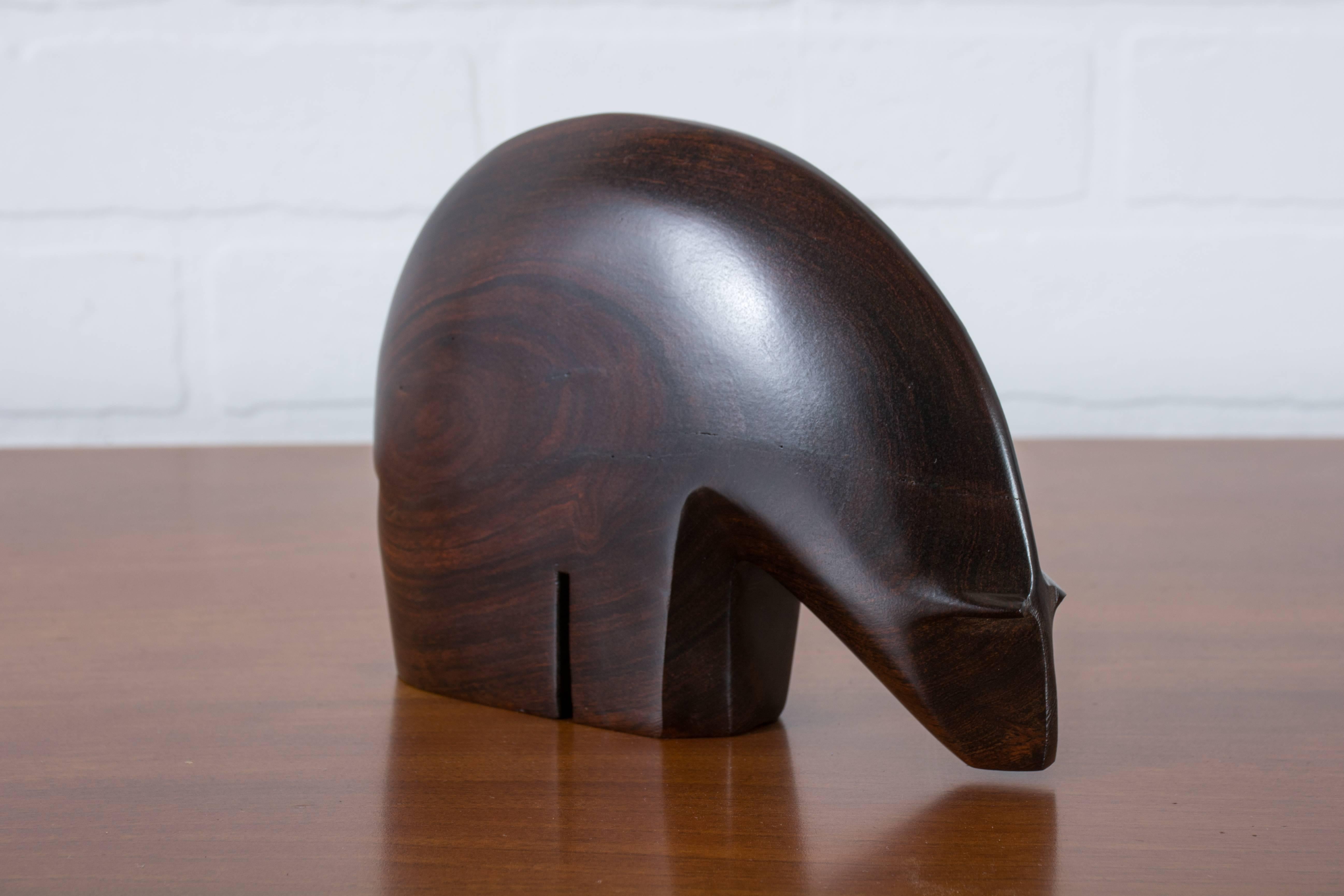 This abstract sculpture of a polar bear was carved out of a solid piece of rosewood. Beautiful curved lines.