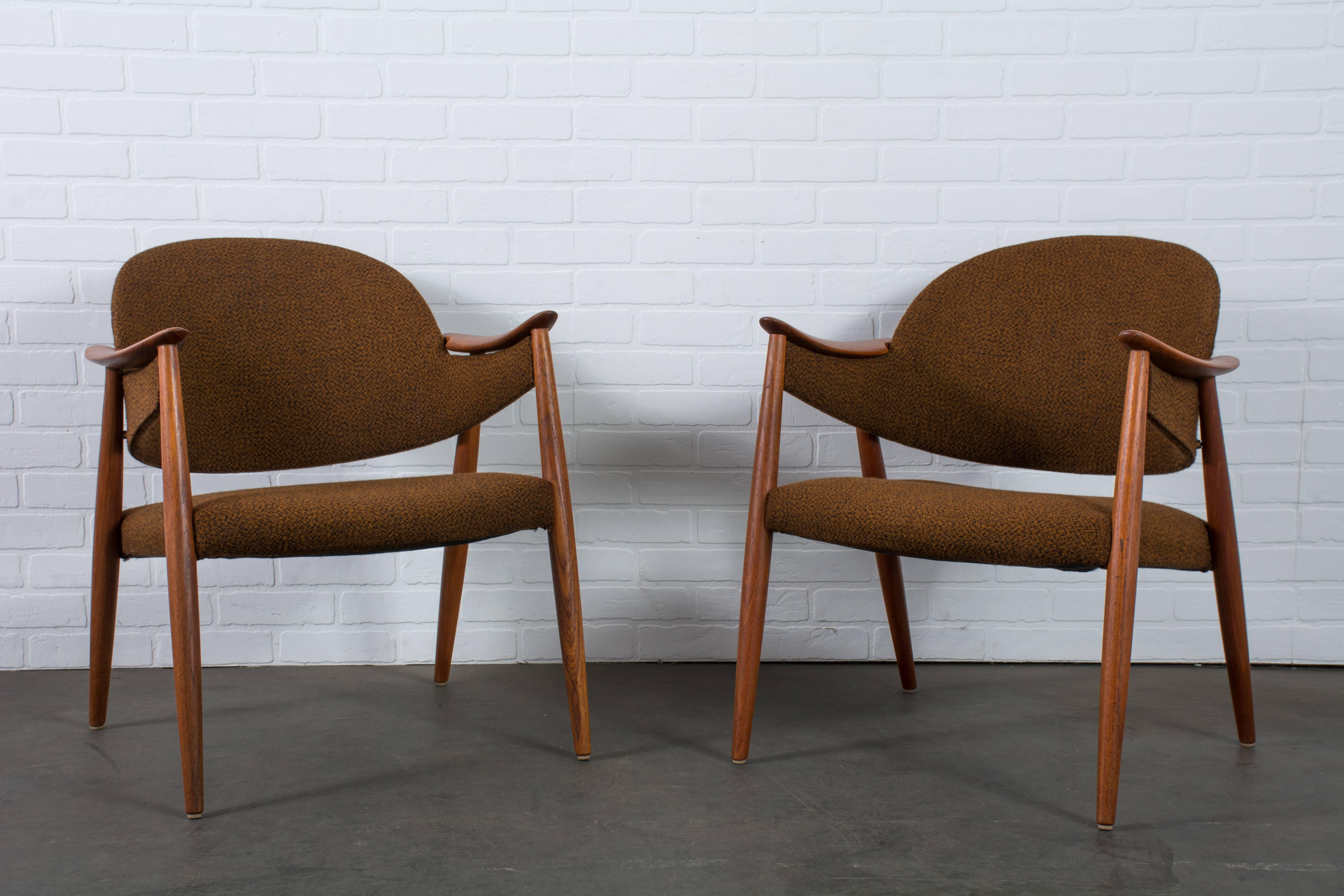 These vintage Mid-Century lounge chairs were designed by Gerhard Berg in the 1950's, Norway. They have teak frames and the original rust/black tweed wool upholstery on the seats and on the curved back rests.
