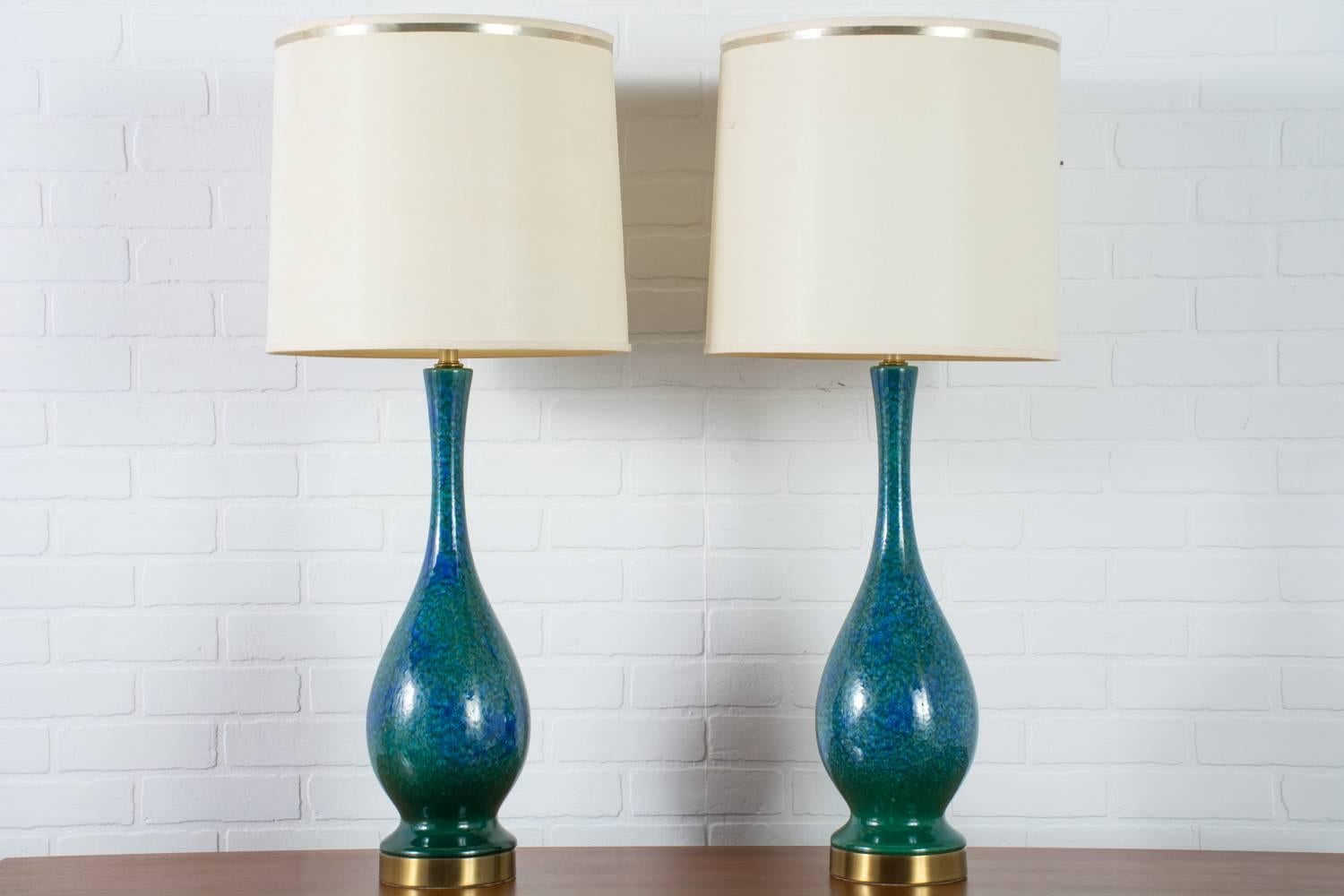 This is a pair of vintage Mid-Century ceramic table lamps glazed in beautiful shades of blue and green. Metal bases have a brass finish. Shades not included.

Measurements: 38 inches H to top of harp (26 inches H to bottom of harp), approximately