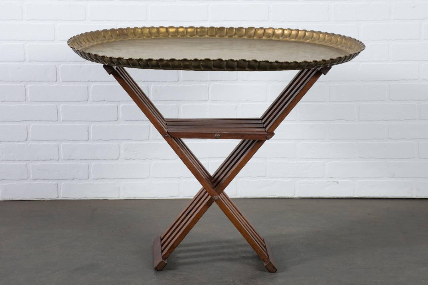 This vintage Mid-Century Moroccan brass tray table has a folding rosewood slat base. Label on the table base reads Fink.