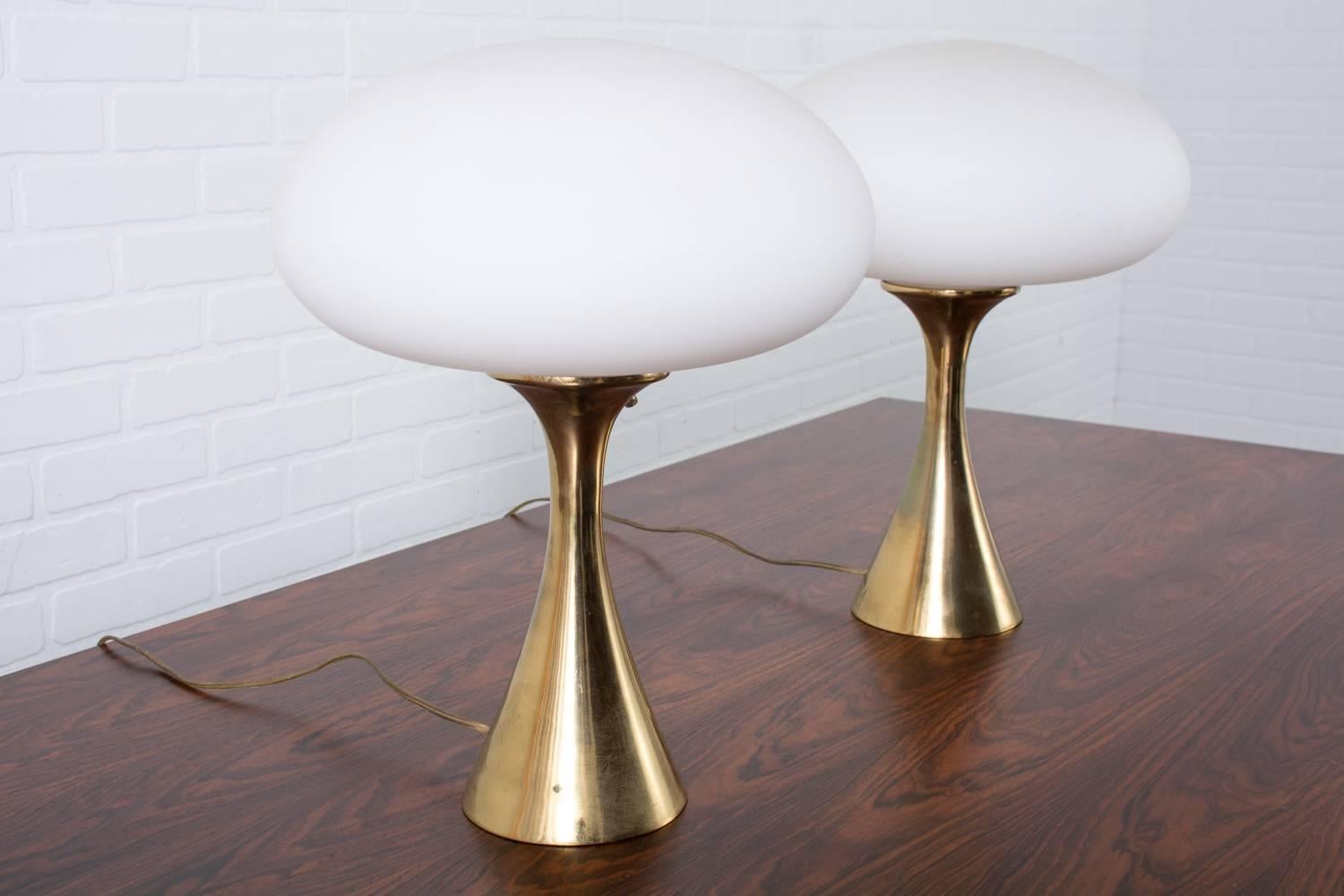These Mid-Century Modern lamps are by Laurel Lamp Company, USA, 1960s. They feature handblown Italian frosted glass shades and brass tulip bases.