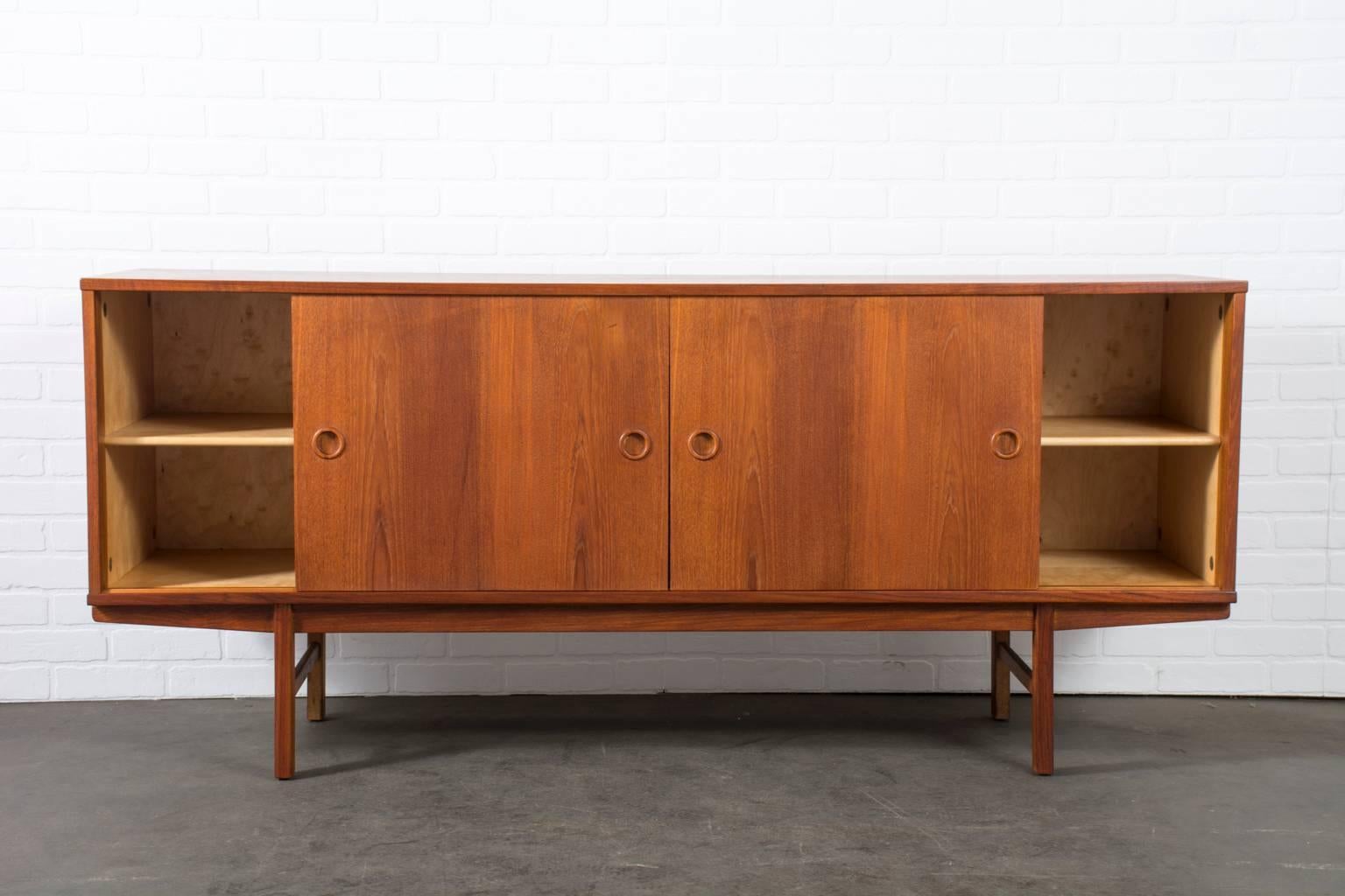 This Scandinavian Modern teak credenza was designed by Yngve Ekstrom for Dux's Carmel Collection (Model 504) in the 1960's. It has two sliding doors and five drawers (one with dividers).  