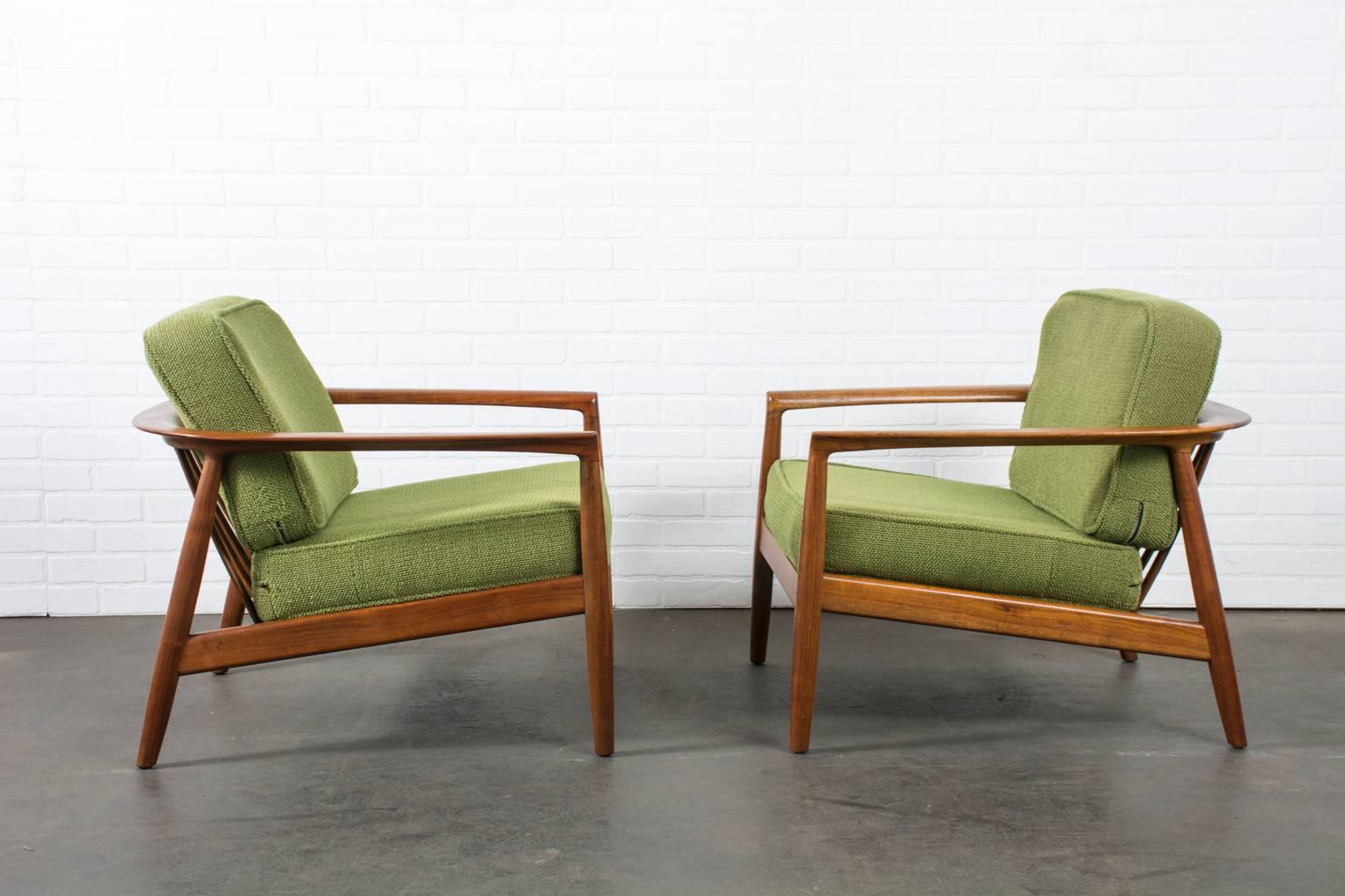 This pair of vintage Mid-Century walnut lounge chairs were designed by Folke Ohlsson for Dux in the 1960's. This particular model is the 72-C 