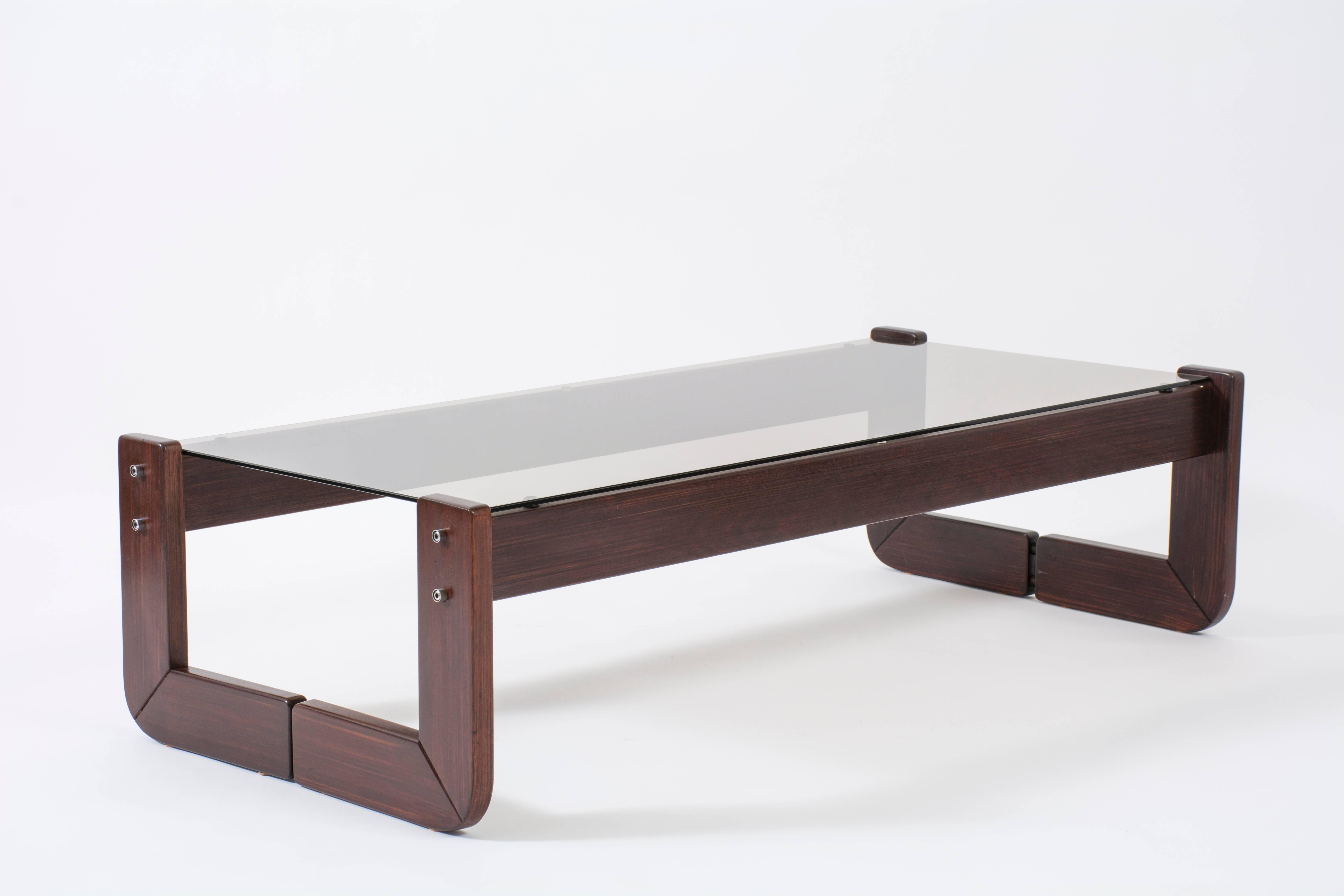 This is a rosewood and bronzed glass coffee table by Percival Lafer.  