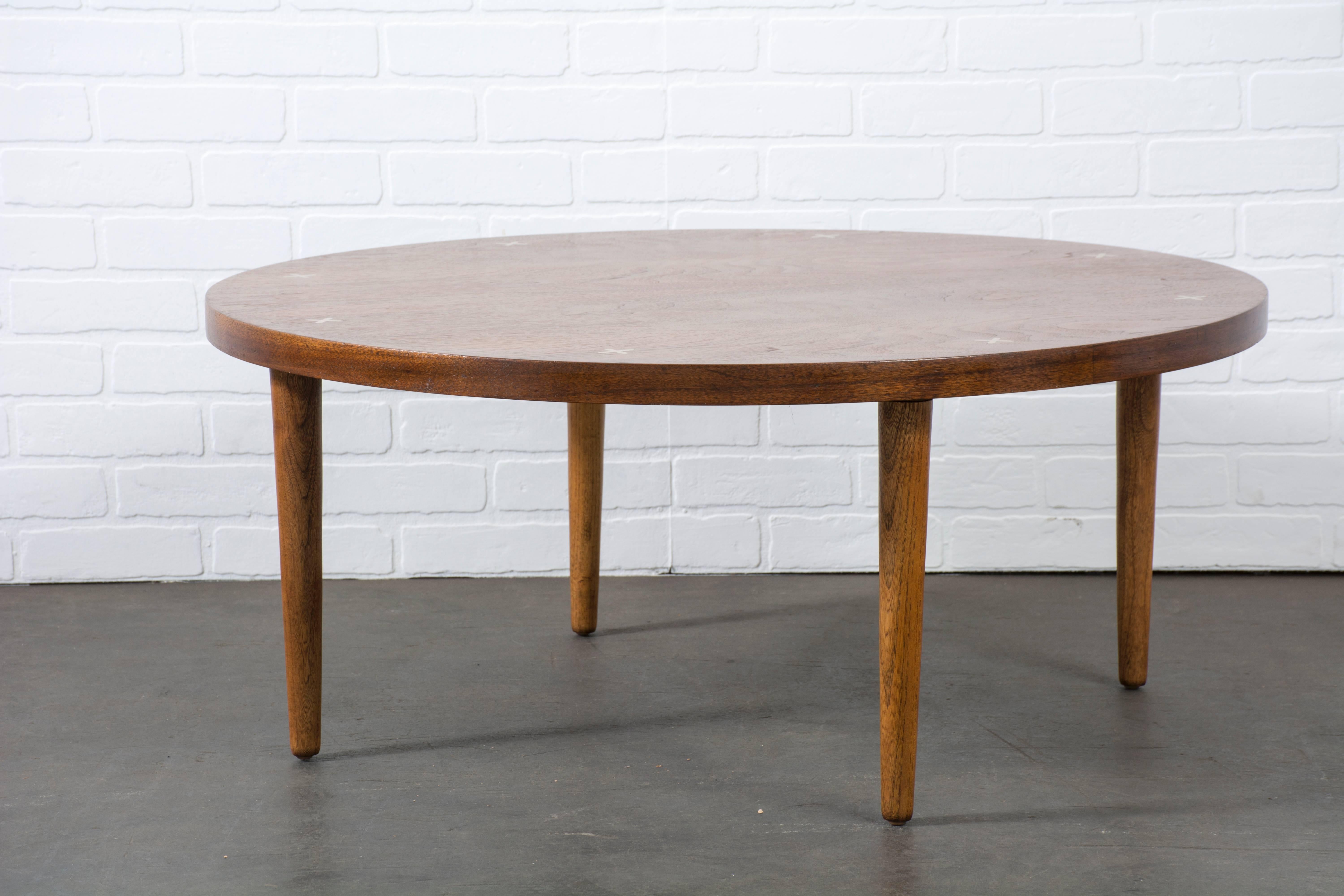 This is a vintage Mid-Century round walnut coffee table by American of Martinsville.
