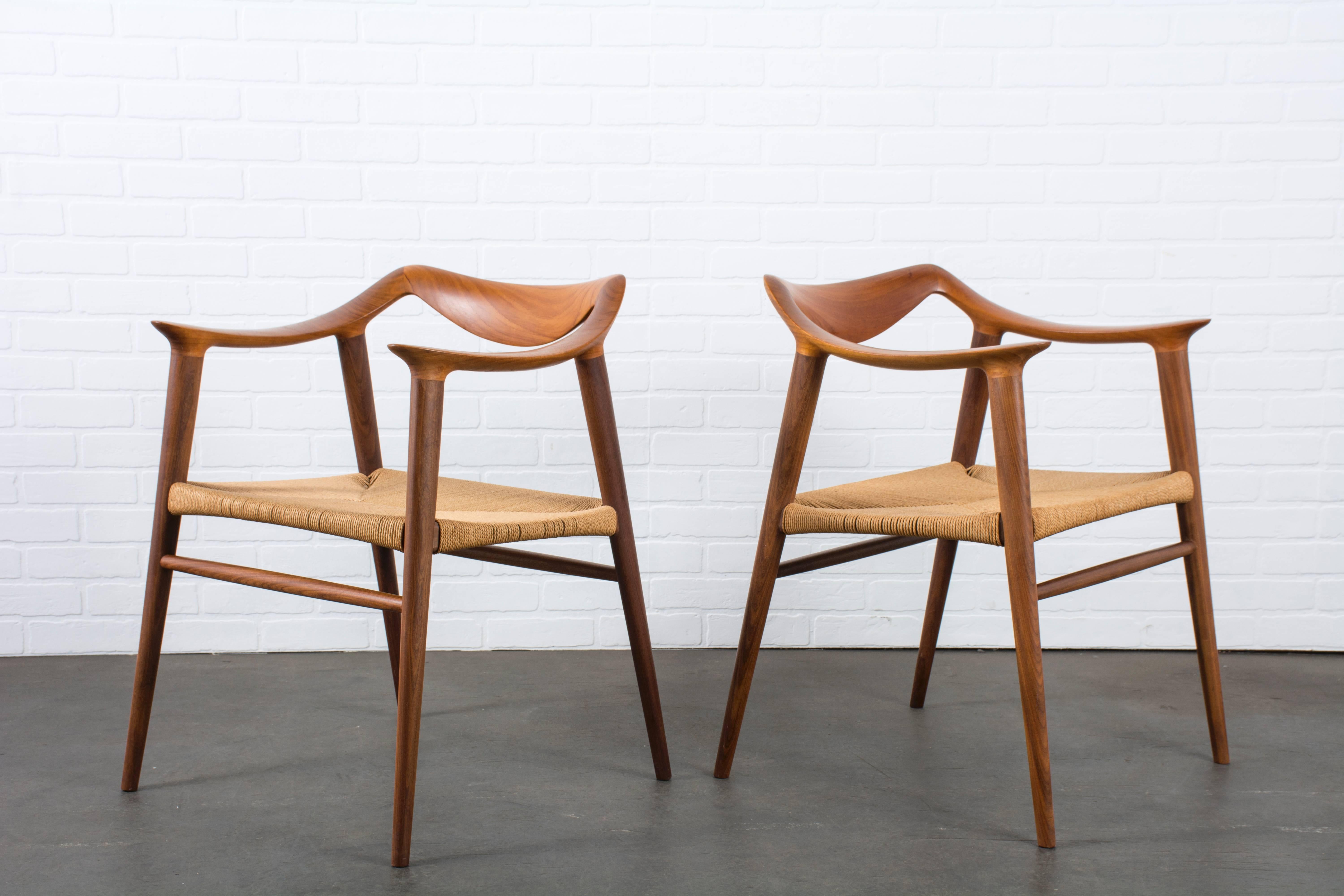 This is a pair of vintage Mid-Century armchairs by Rolf Rastad & Adolf Relling for Gustav Bahus, Norway, circa 1950s. They feature sculptural teak frames and the original paper cord seats.