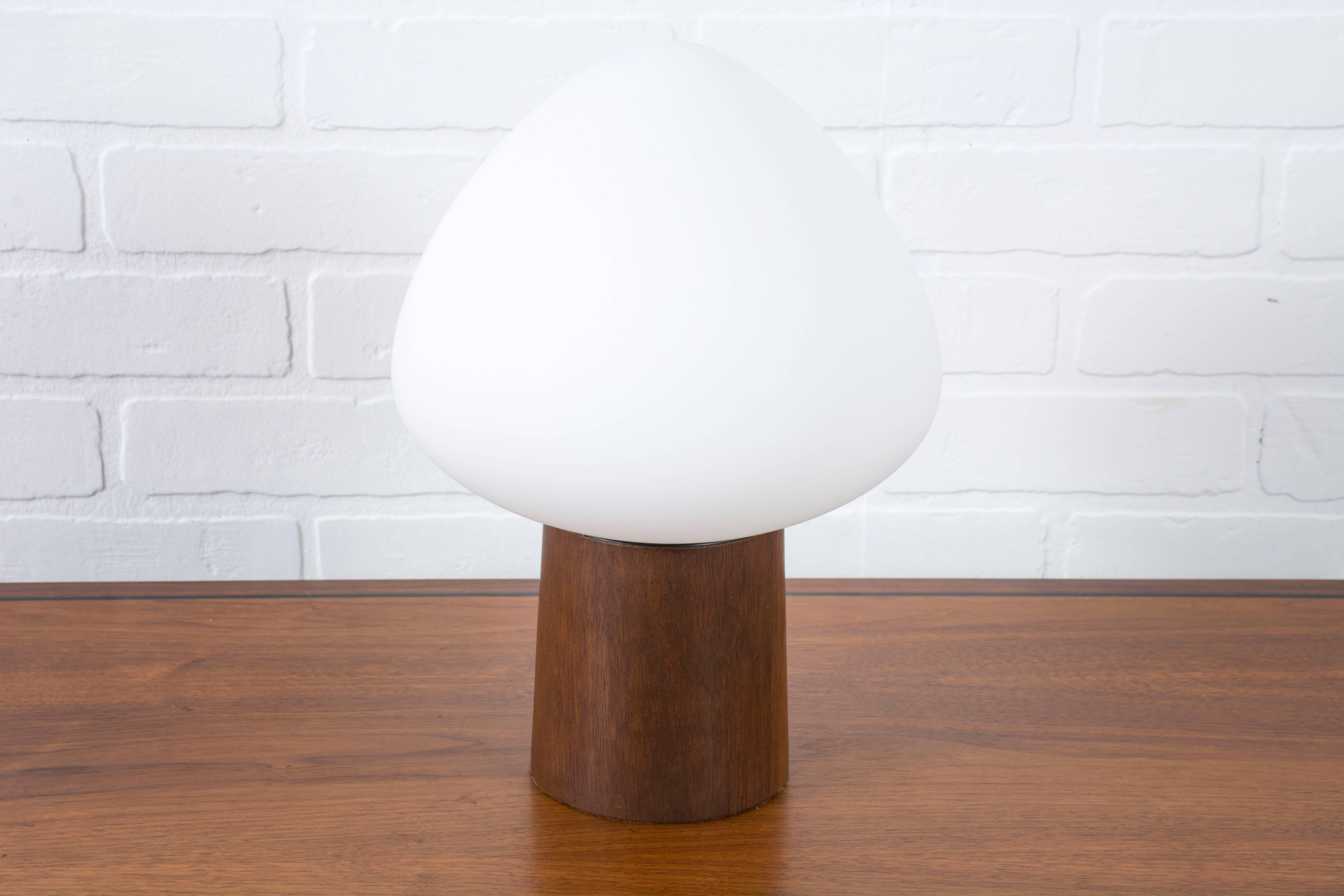 This vintage Mid-Century table lamp by Laurel Lamp Co. has a walnut base and al frosted glass shade. Switch is on the base. Circa 1960's.
