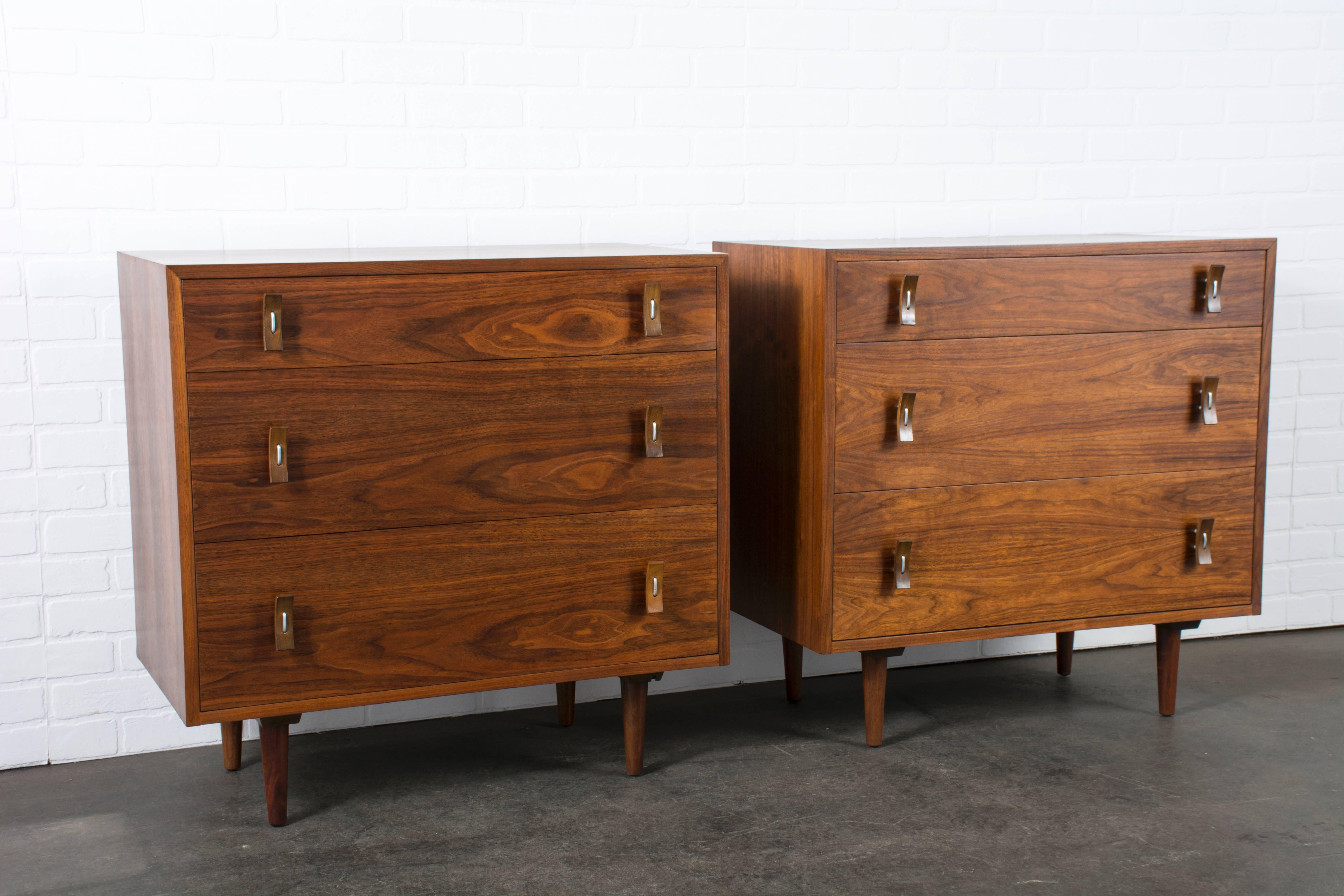 This pair of Mid-Century Modern walnut dressers was designed by Stanley Young for Glenn of California in the 1950s.