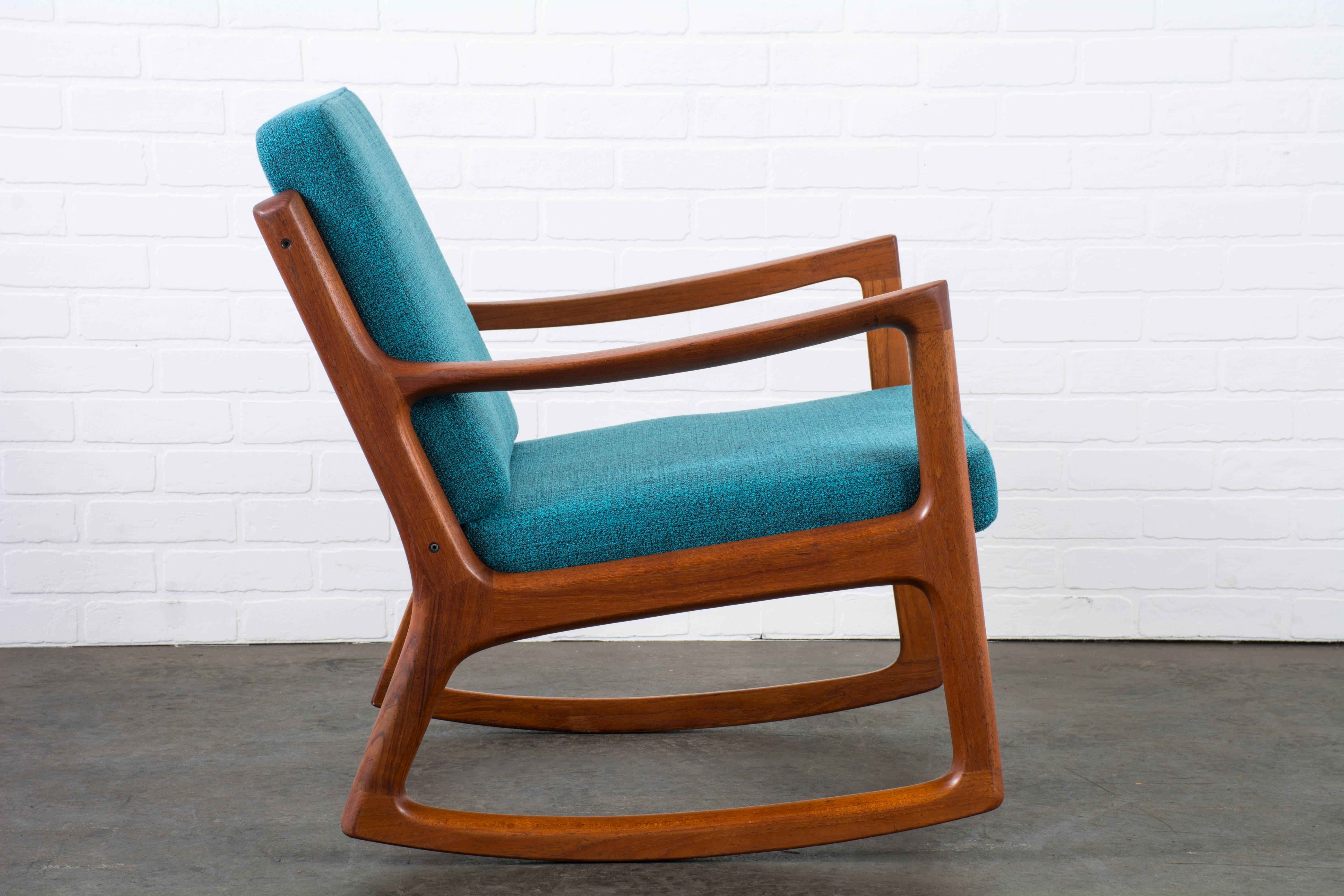 This vintage Midcentury teak rocking chair was designed by Ole Wanscher for France & Daverkosen in the 1950s, Denmark. New Danish teal upholstery and new cushion inserts.
