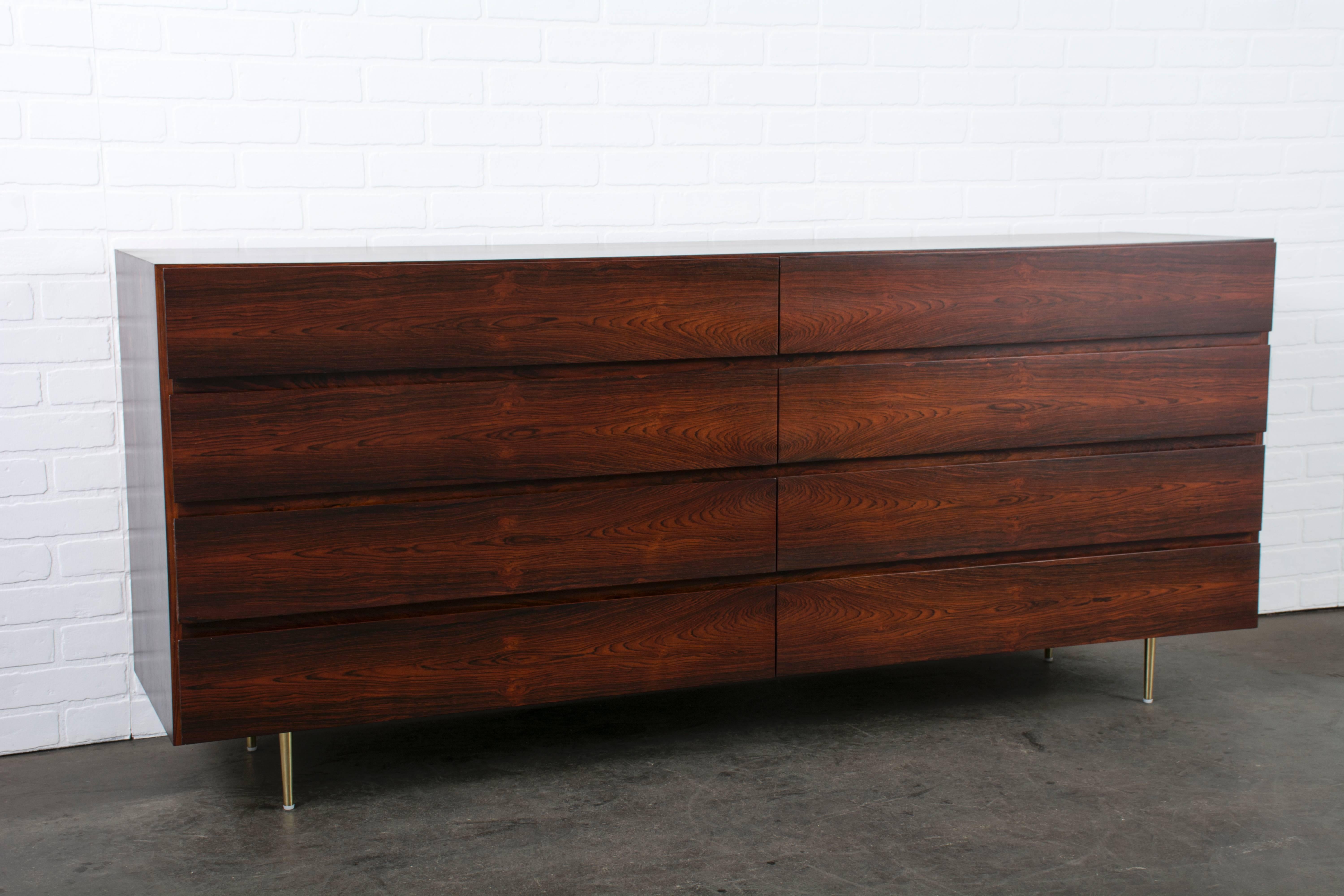 This vintage Mid-Century rosewood eight-drawer dresser is stamped Vamo, made in Denmark. It features new solid brass legs.