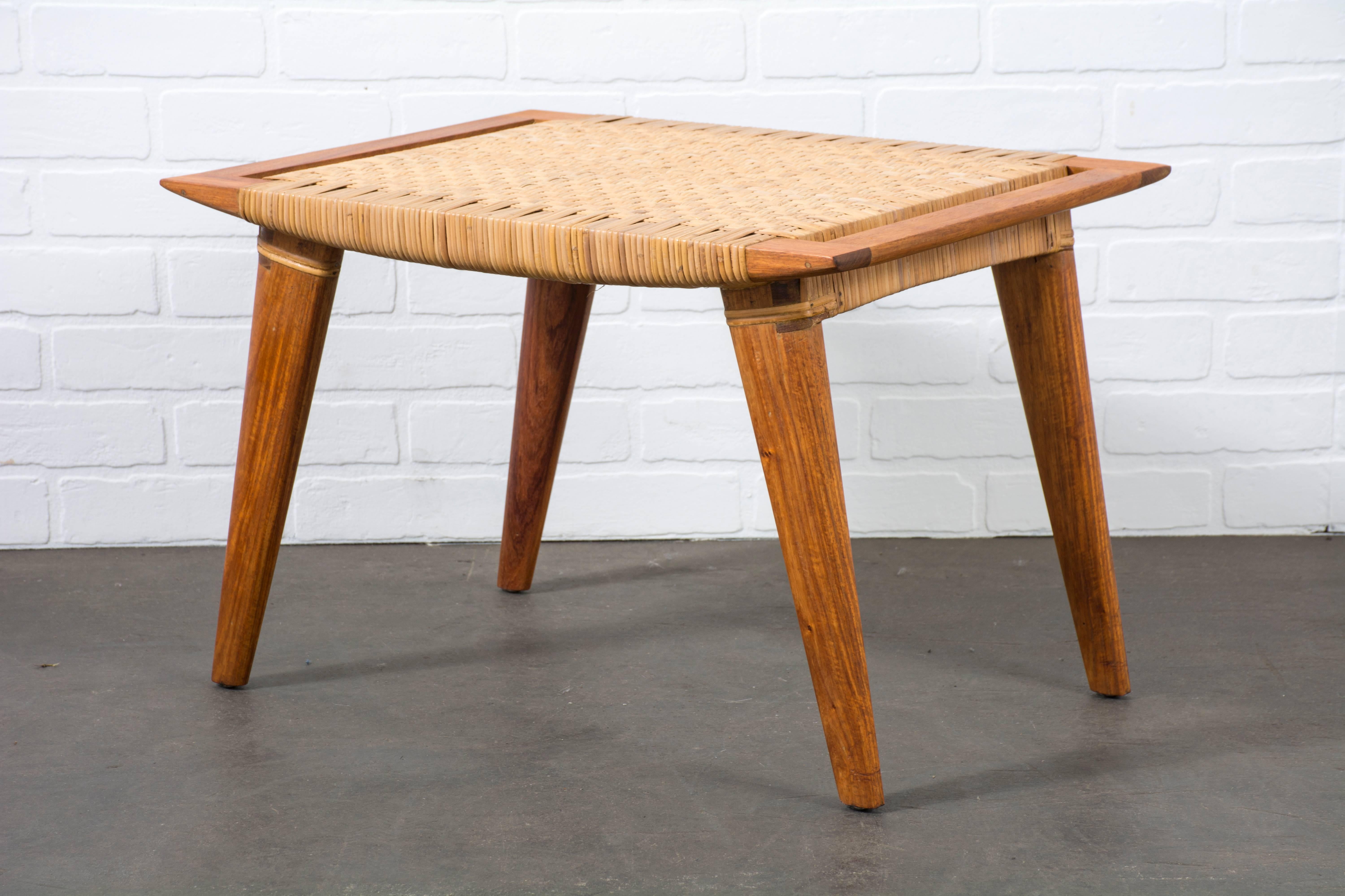 This is a Mid-Century Modern Dao wood and cane stool.