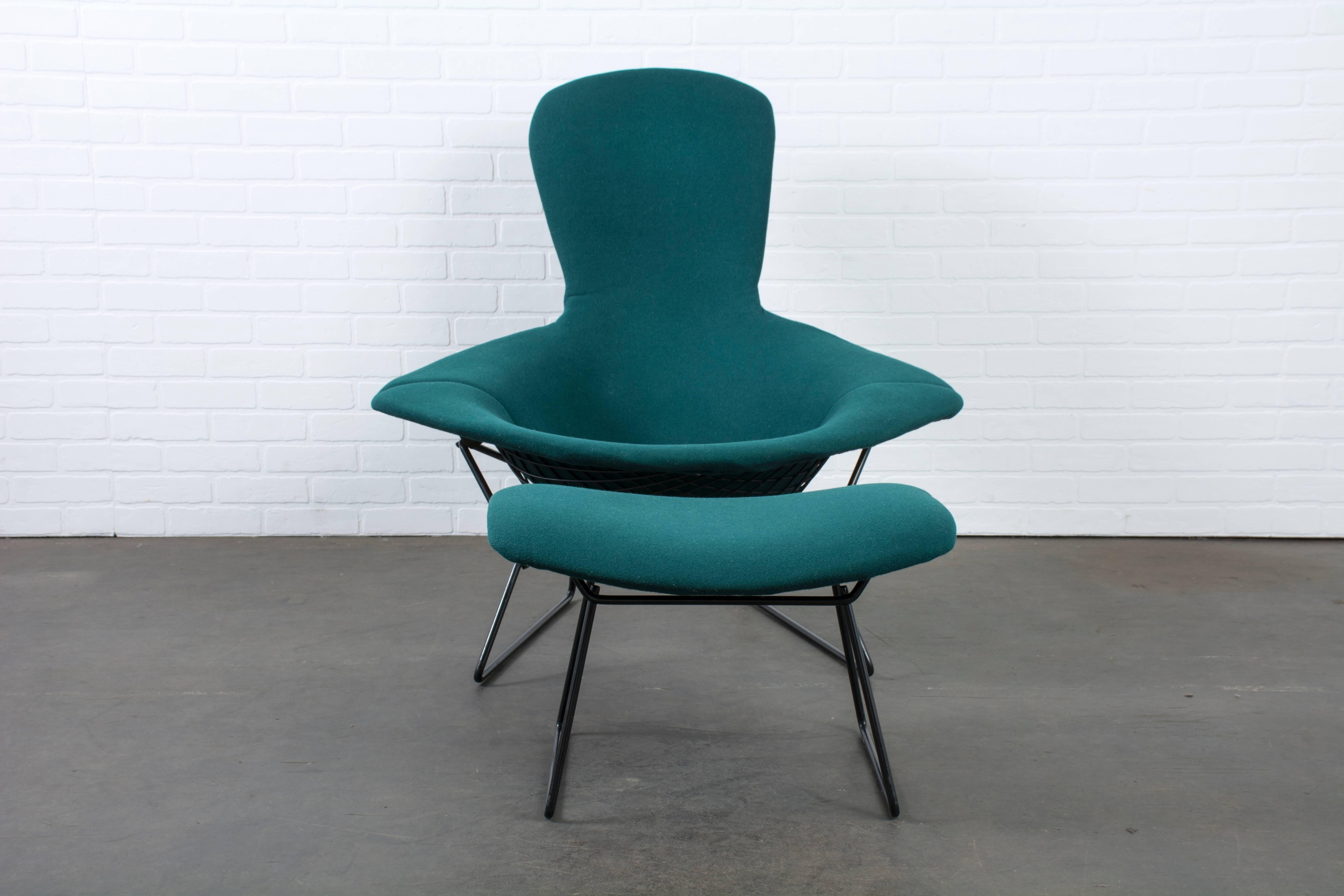 The 'Bird' chair was designed by Harry Bertoia for Knoll in 1952. This lounge chair and ottoman have a black frame and removable dark green cover.

    