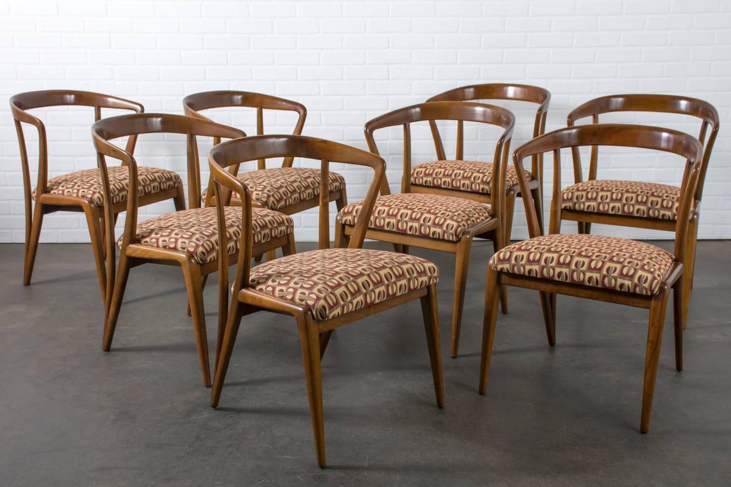 These Mid-Century Modern dining chairs were designed by Bertha Schaefer (American, 1895-1971) and produced for Singer and Sons, USA, circa 1950s. They have sculptural solid walnut frames and vintage upholstery.