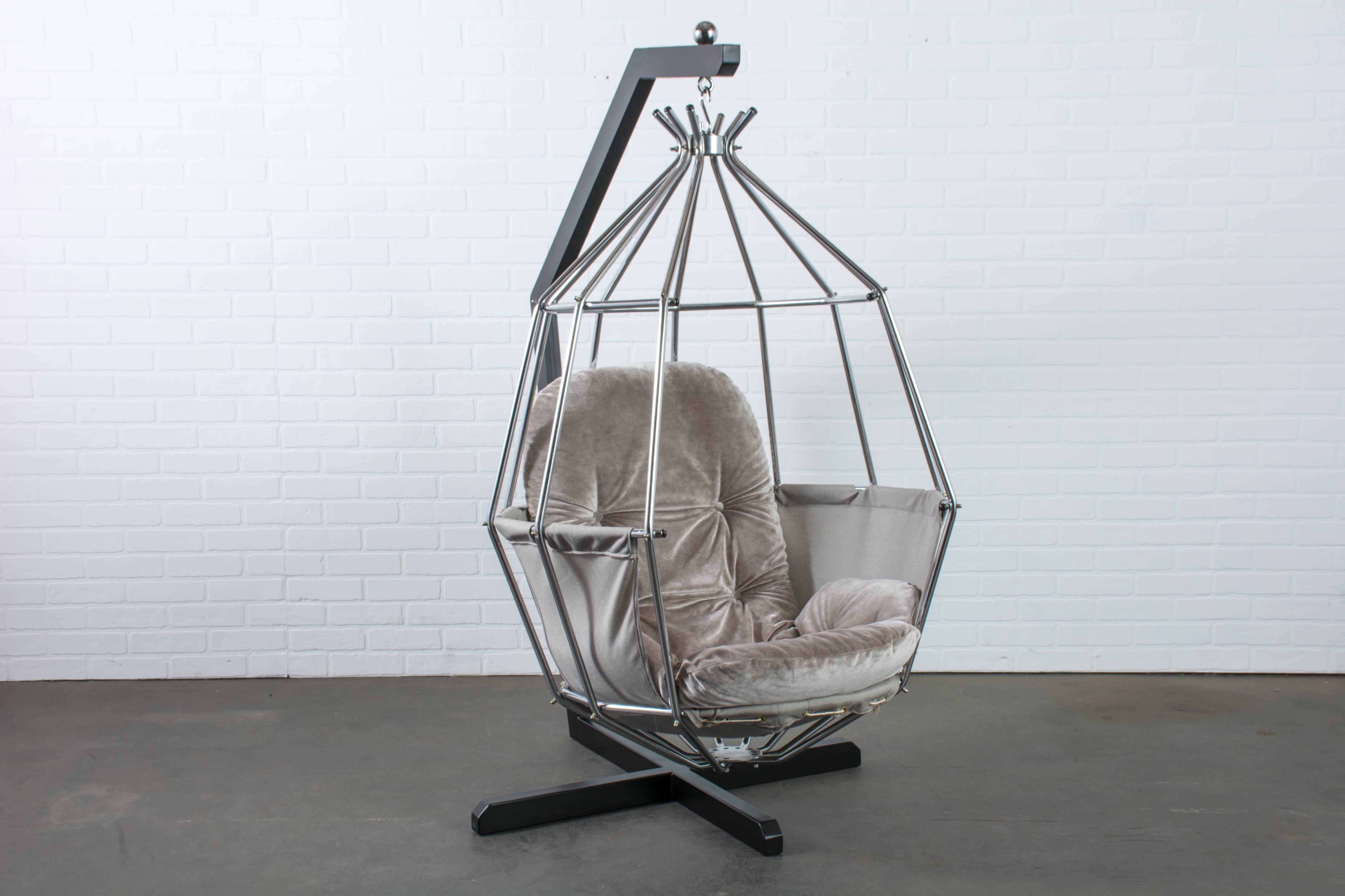 This vintage Mid-Century parrot chair was designed by Ib Arberg in the 1970s, Sweden.  It features a chrome bird cage chair that hangs from a steel angular stand with a black finish.  The original cushion has been professionally reupholstered in