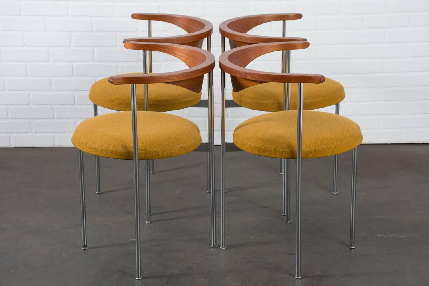 These vintage Mid-Century chairs were designed by Frederik Sieck for Frtiz Hansen, Denmark, in the 1960s (model 3200). They feature chrome-plated steel frames with curved teak backs and round seats upholstered in mustard yellow wool.