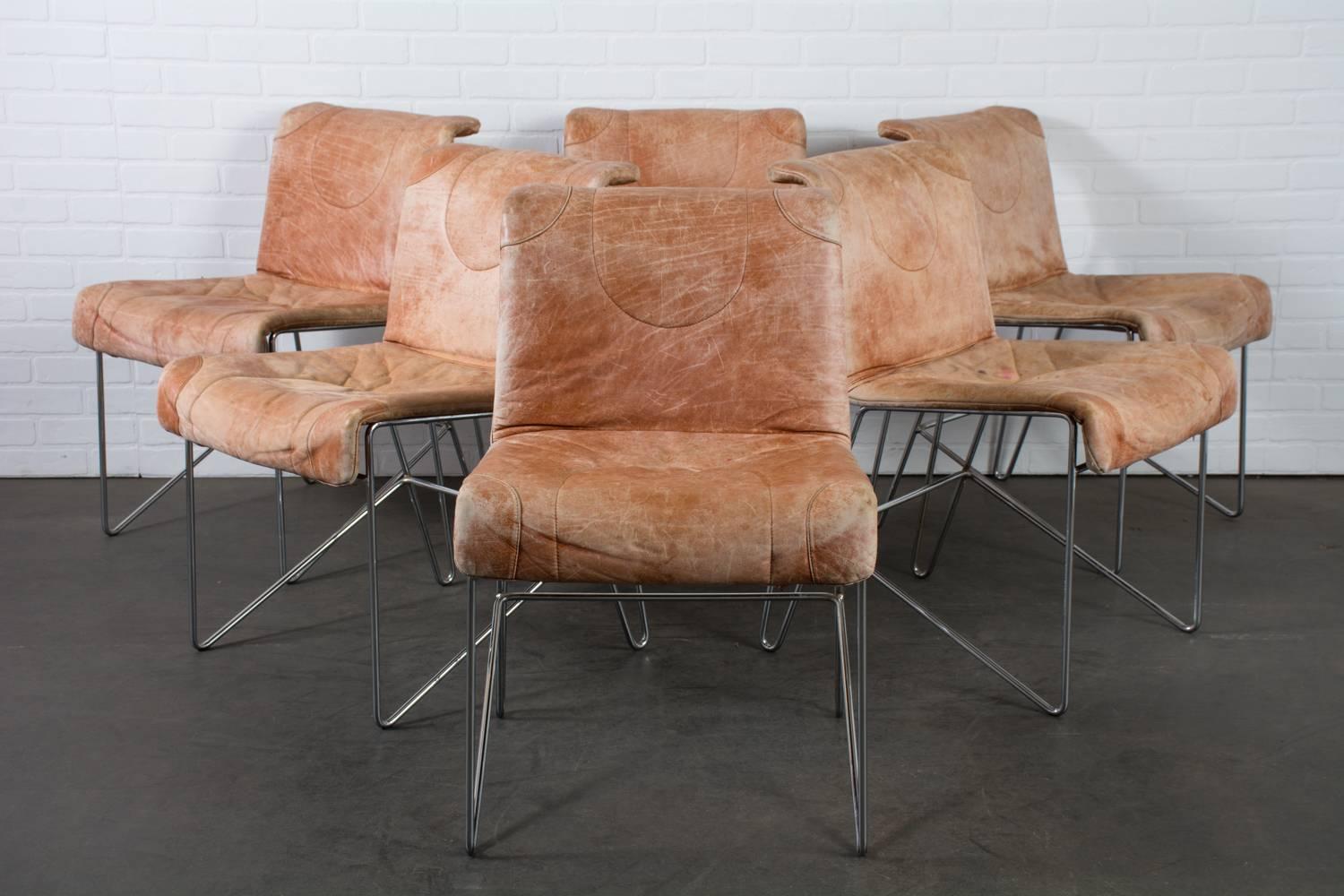 This set of six vintage midcentury Italian dining chairs are by i4 Mariani. We believe they were designed by Guido Faleschini who designed many chrome and leather chairs for i4 Mariani in the 1960's and 1970's. These chairs have metal bases with a
