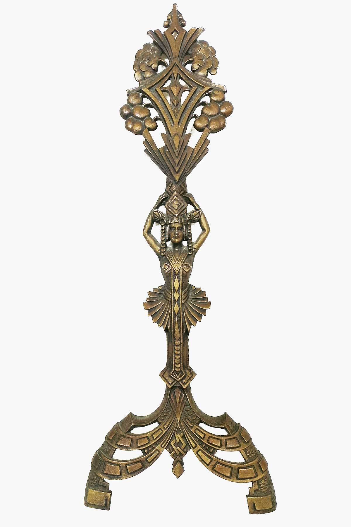 A unique pair of Egyptian Revival cast iron andirons. Each features a female figure, Egyptian motifs, and stylized geometric forms typical of the Art Deco period.
Stamped 