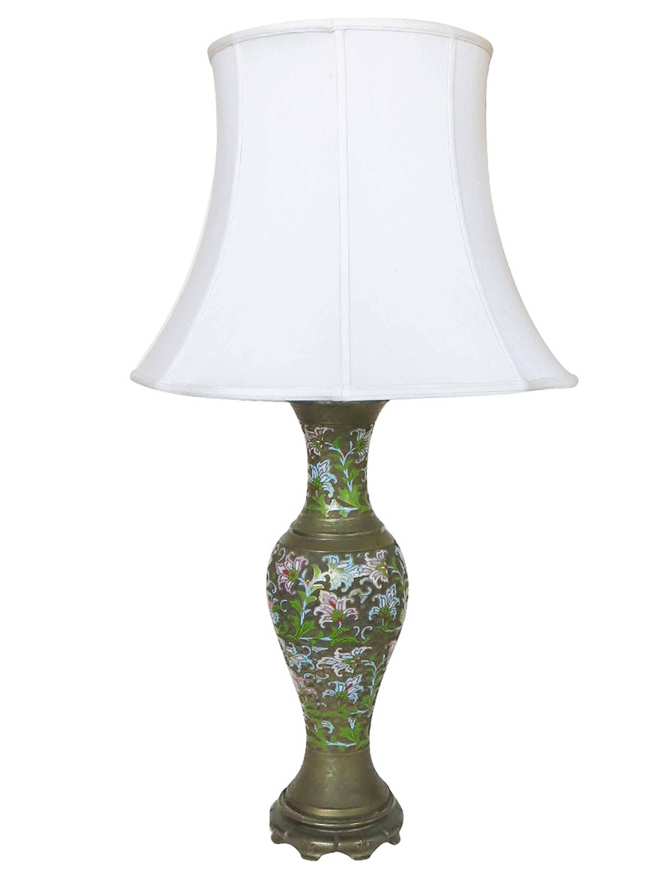 Pair of Chinese Cloisonne Champlevé brass lamps with multicolored enamel floral along the outside and white lamp shades.

Circa 1950

Champlevé is an enameling technique in the decorative arts or an object made by that process, in which