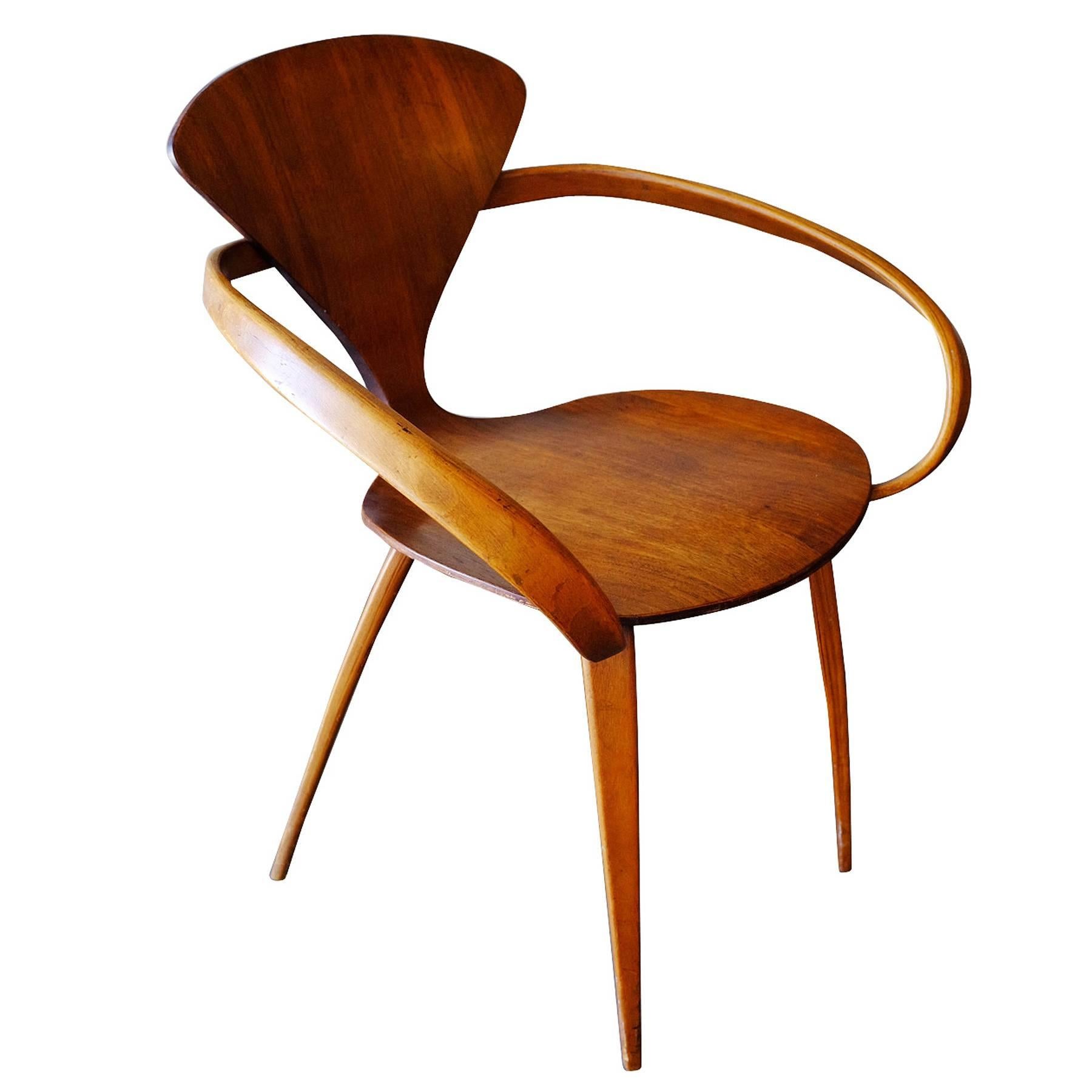 Plycraft sculptural walnut dining armchair designed by Norman Cherner made from steam form bent walnut plywood,

circa 1950.