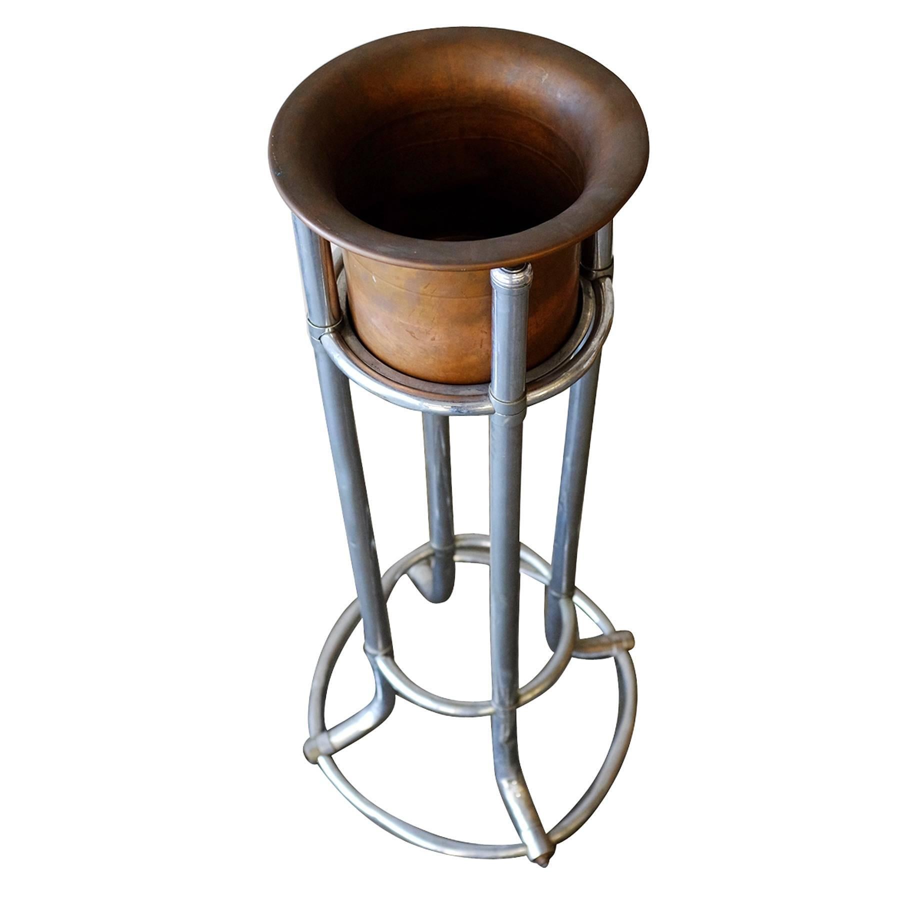 This champagne ice bucket stand is from the original Ambassador Hotel in Los Angeles, circa 1921. Featuring a chromed steel bucket stand and a copper ice bucket. 

These were used in the hotel dining room and in the Coconut Grove, a famous hang