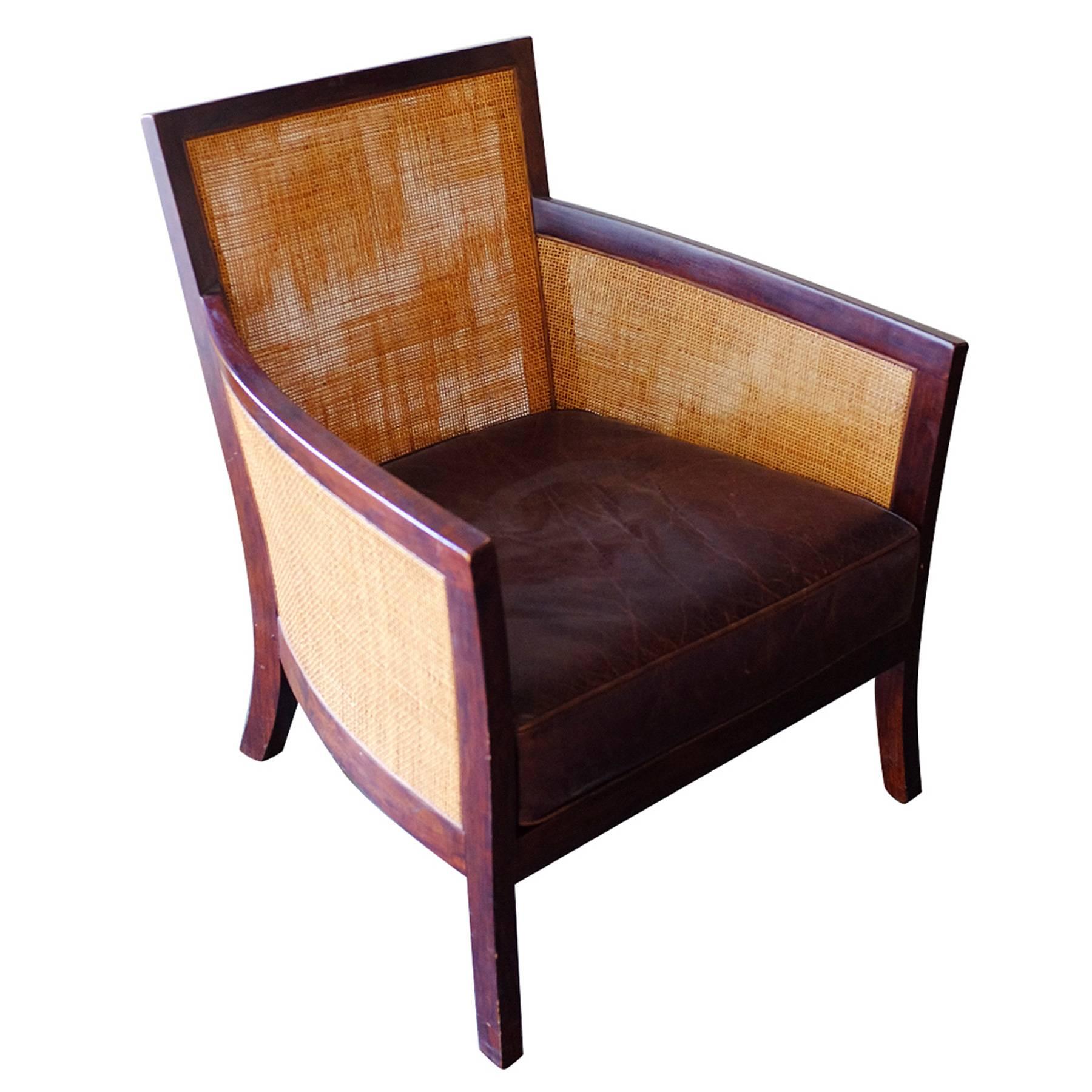 Contemporary dark stained wicker lounge chair with velvet seat.