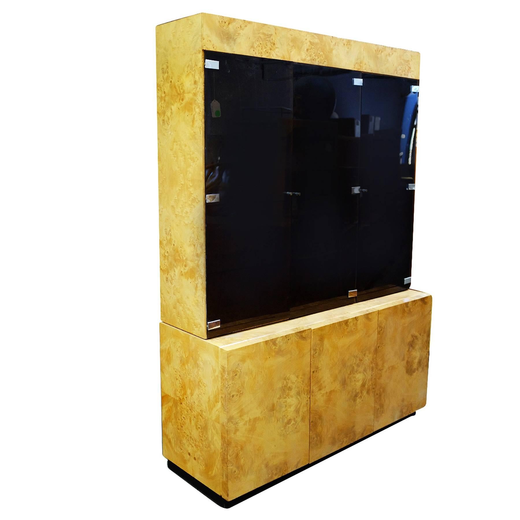 Large Postmodern burl elmwood cabinet featuring a breakfront with three smoked glass doors containing adjustable Glass shelves inside and three cabinets underneath. There are three recessed lights along the inside of each cabinet.

This cabinet was