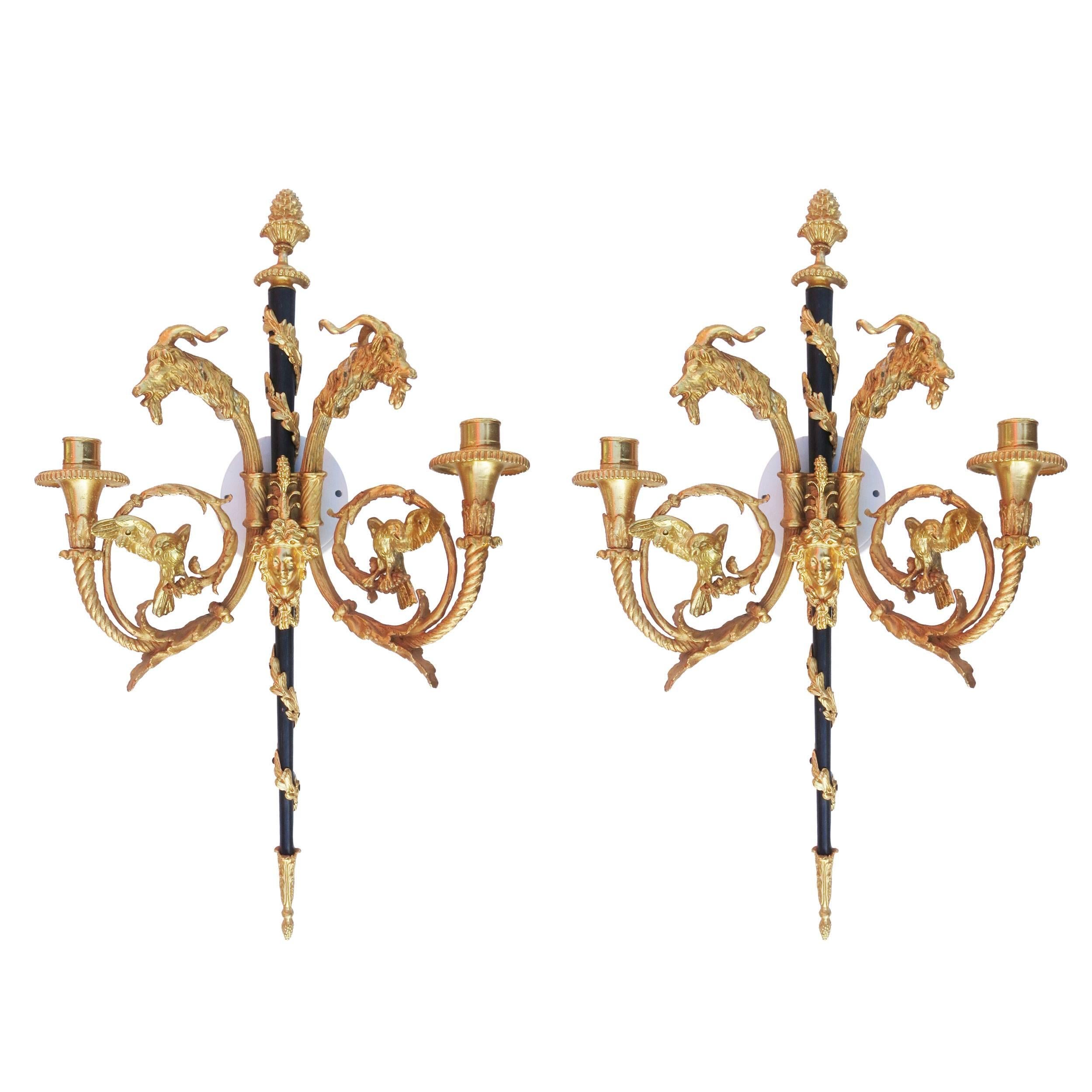 Empire style 24-karat plated bronze candle stick wall sconce pair with goat heads in the front center and two heavily decorated arms.

***No wiring for candles only*****

Product handcrafted in the USA with the highest quality materials and over 30
