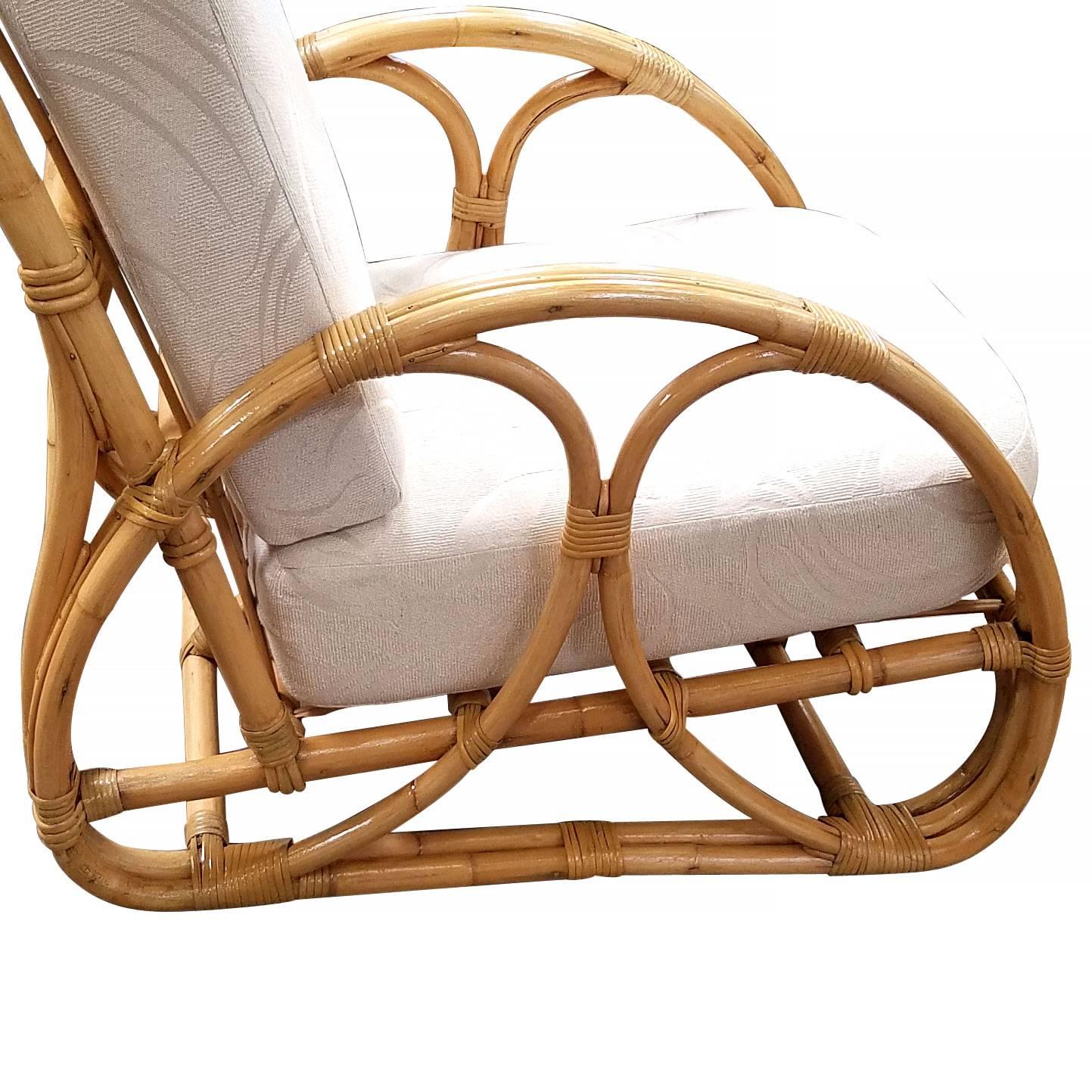 Shirley Ritts style two strand "Double Hoop" Rattan lounge chair featuring two strand rattan arms with double hoop accents in the center. Stick Rattan strips and wicker wrapping ordain the frame of this chair.

Refinished to new for