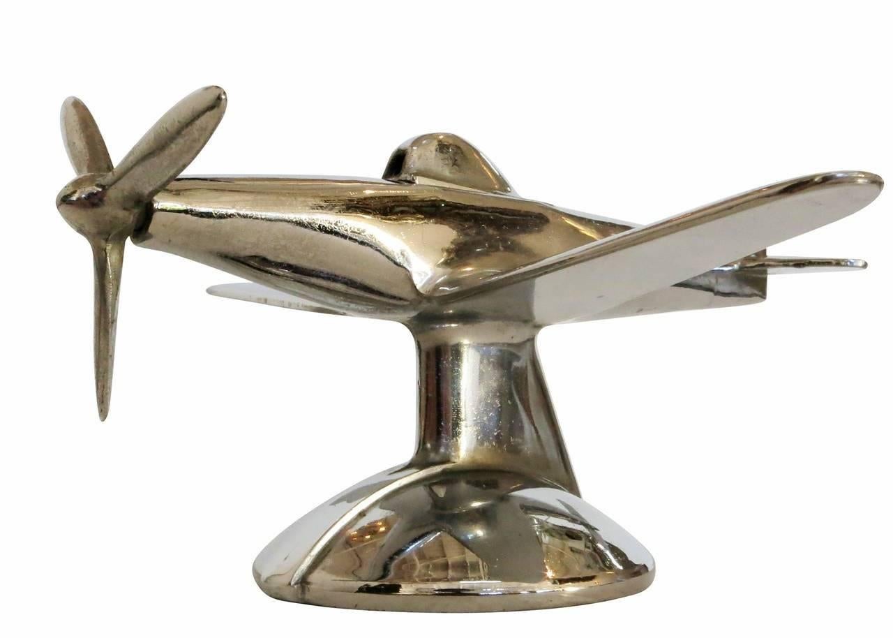 Mid-Century era Negbaur made desktop airplane lighter modeled after the North American P-51 Mustang II fighter plane used heavily in World War II. This Lighter features a chrome-plated metal body and simply modernist design.

Upon turning the
