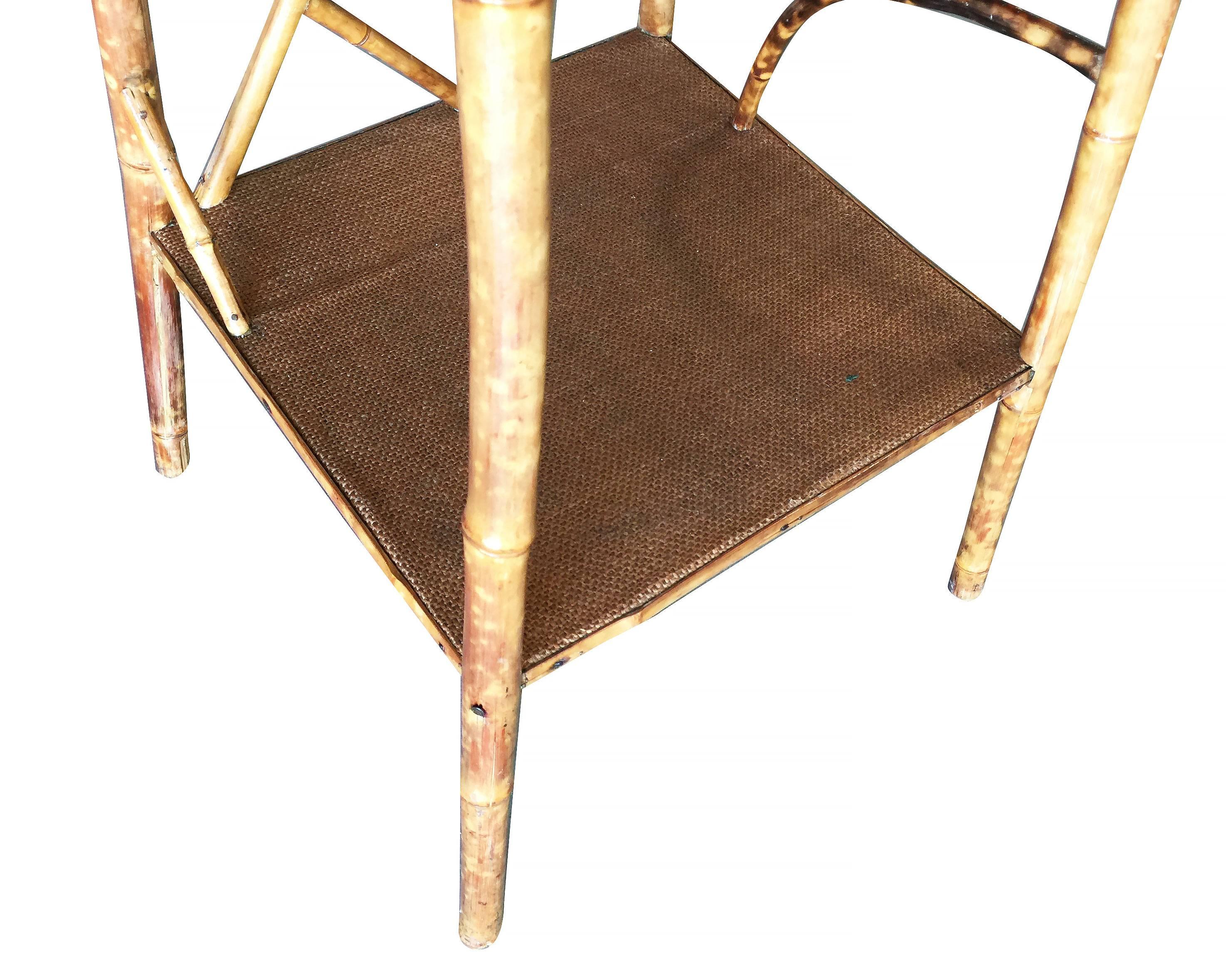 Antique tiger bamboo pedestal side table with rice mat top, organically formed accents and secondary bottom shelf.


Restored to new for you.

All rattan, bamboo and wicker furniture has been painstakingly refurbished to the highest standards with