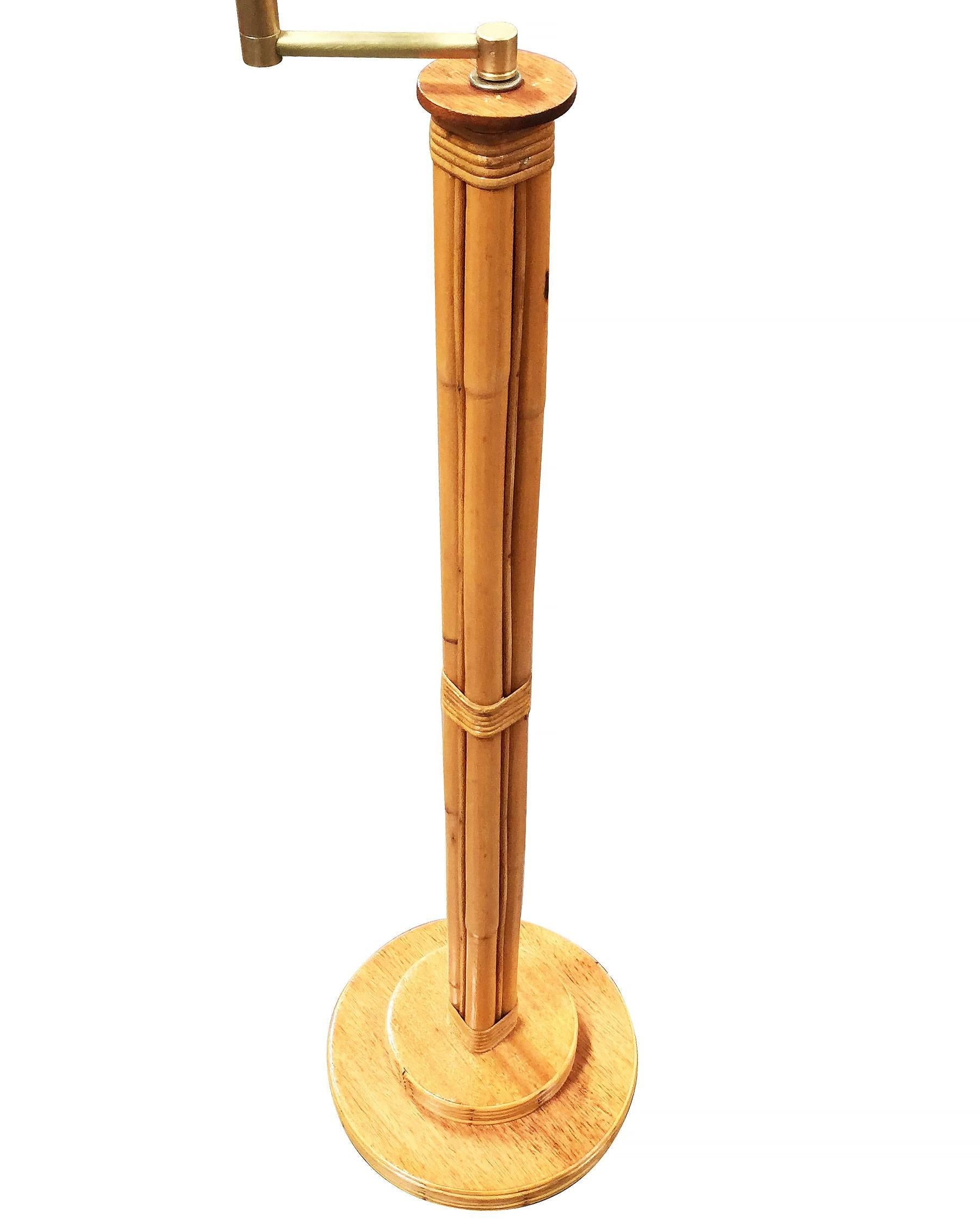 Rattan pole floor lamp featuring 4 decorative rattan poles centered around a rattan post all fixed to a mahogany and rattan circular base, circa 1950. 

The brass swing arm has two points of articulation for easy adjustment. 


Restored to new for