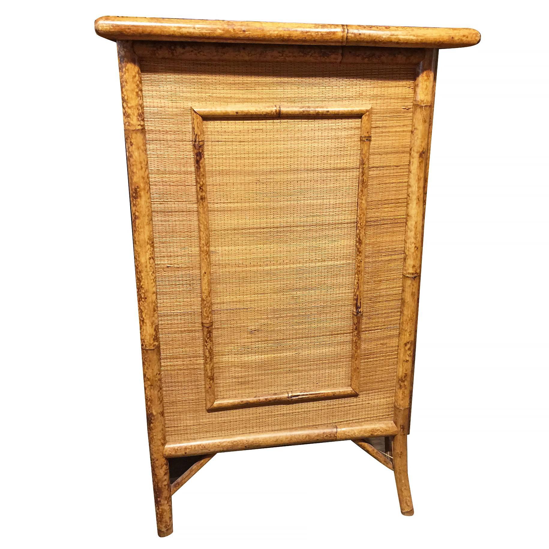 Aesthetic Movement Tiger bamboo lowboy chest of drawers with handwoven rice mat coverings, three large center drawers and two small top drawers. 

Restored to new for you.

All rattan, bamboo and wicker furniture has been painstakingly refurbished