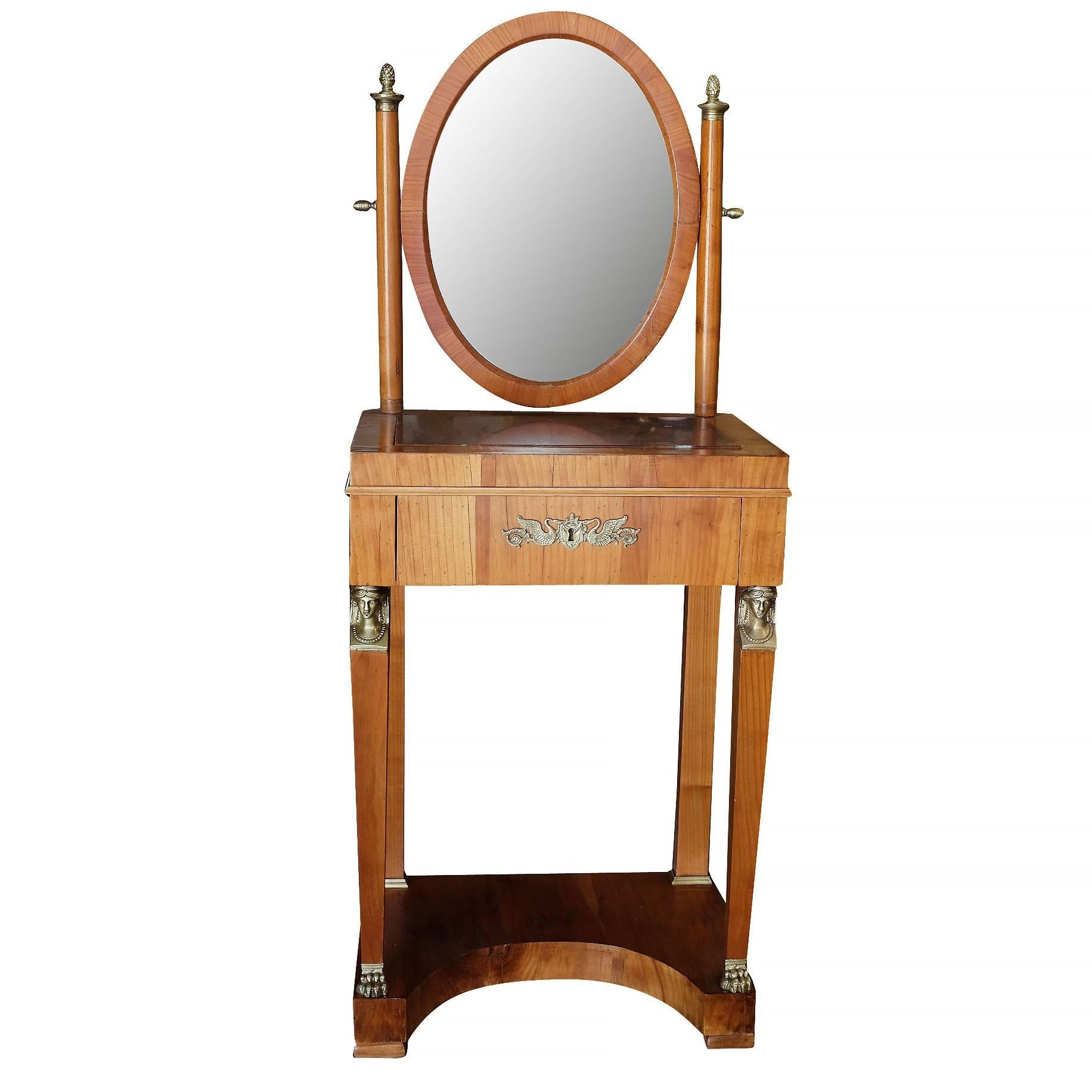 A French Charles X mahogany dressing table with original marble-top and bronze decoration.