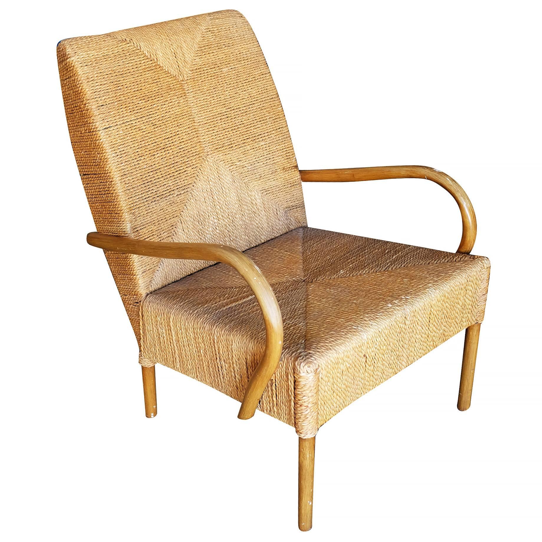 Large wicker rush seat lounge chair with bent hardwood arms and unique wraparound wicker rush seat.