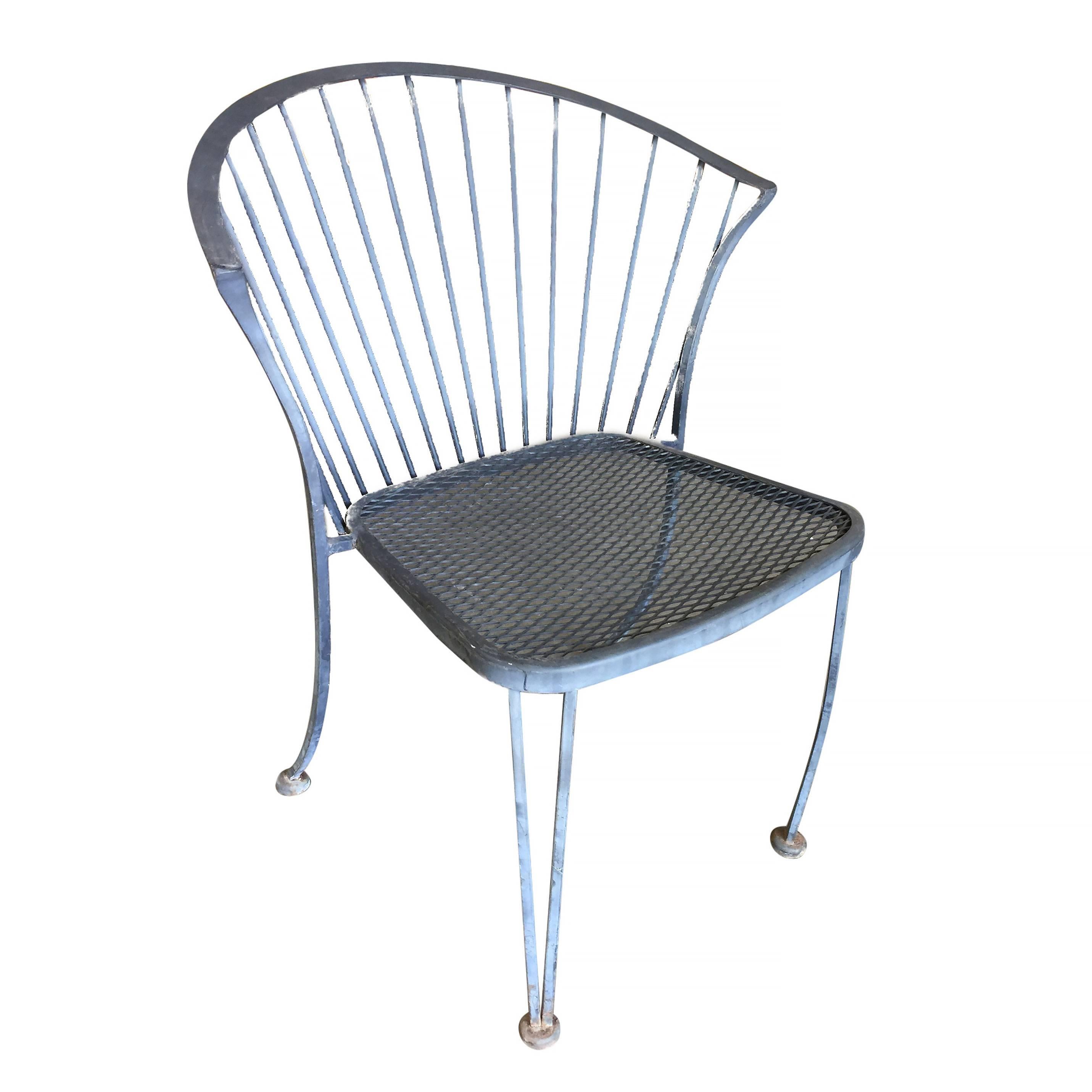 Set of four Woodard Pinecrest rod iron outdoor/patio chair with distinct curved modernist backrest. This chair is constructed with solid core iron rods finished in a pure white finish and a padded seat.

Available.
