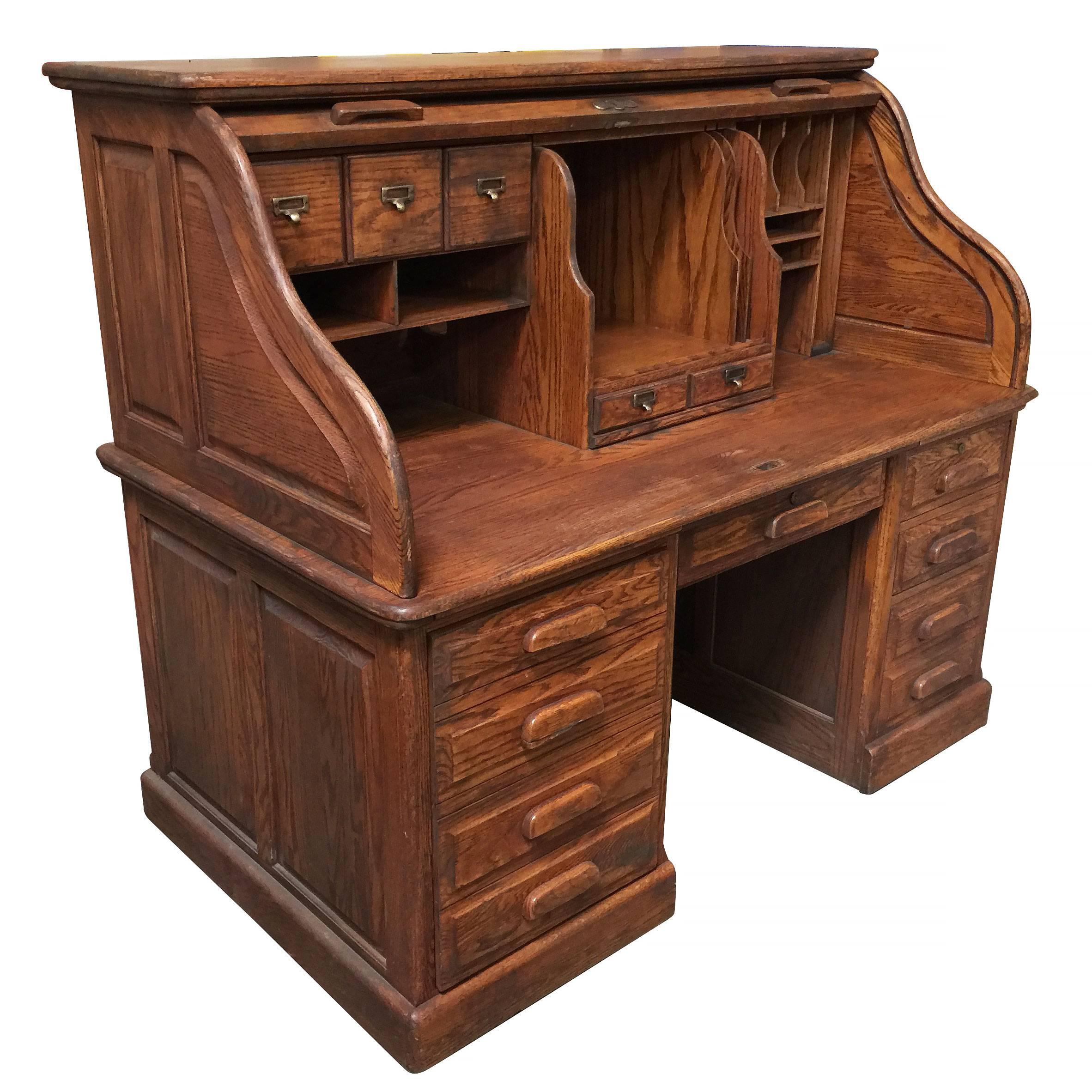Mission style hardwood roll up desk by Stuarts featuring a keyboard drawer and large pull-out drawer to fit a computer tower.
