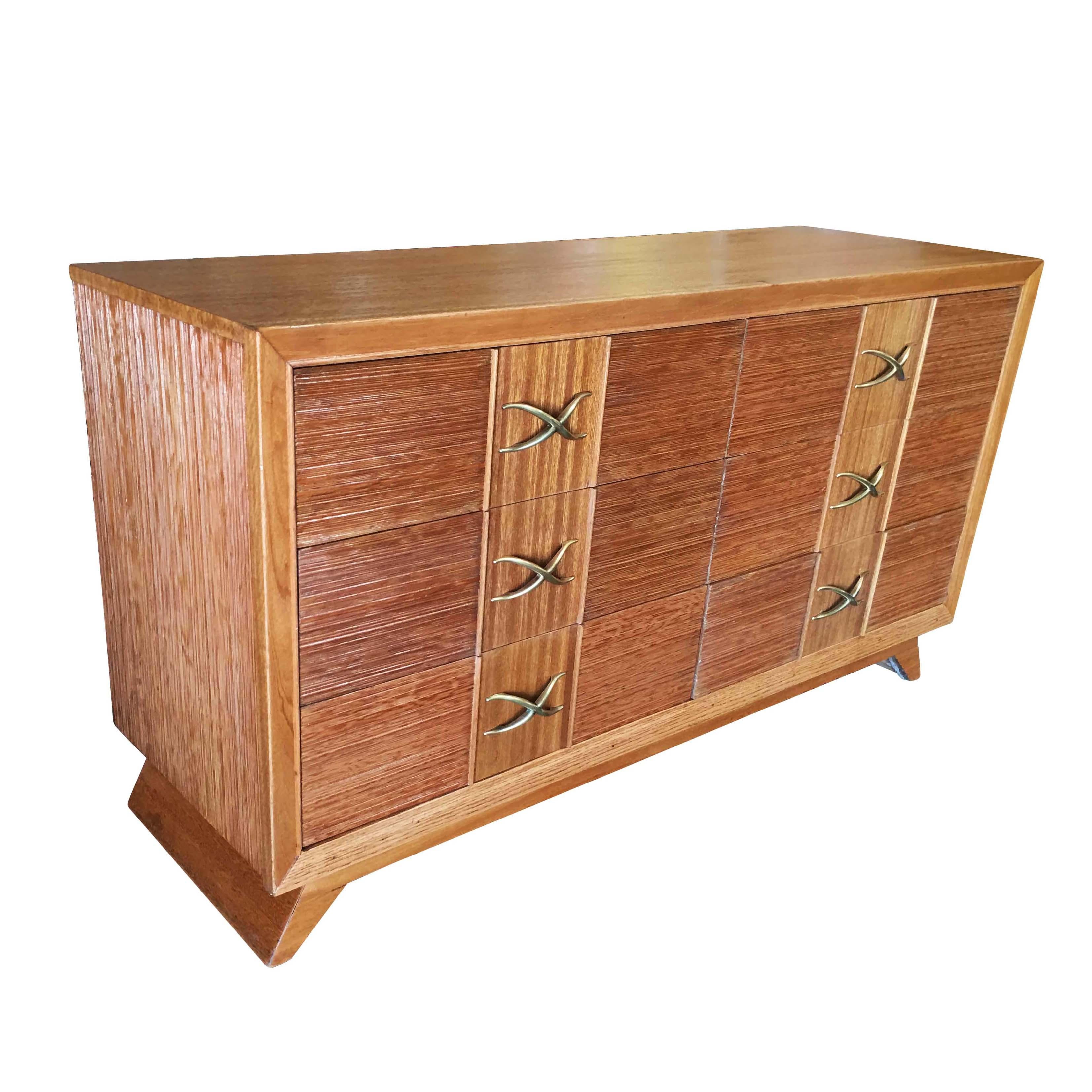 Mid Century dresser by Paul Frankl for Brown Saltman company features his trademark combed wood sides with curled brass pulls.