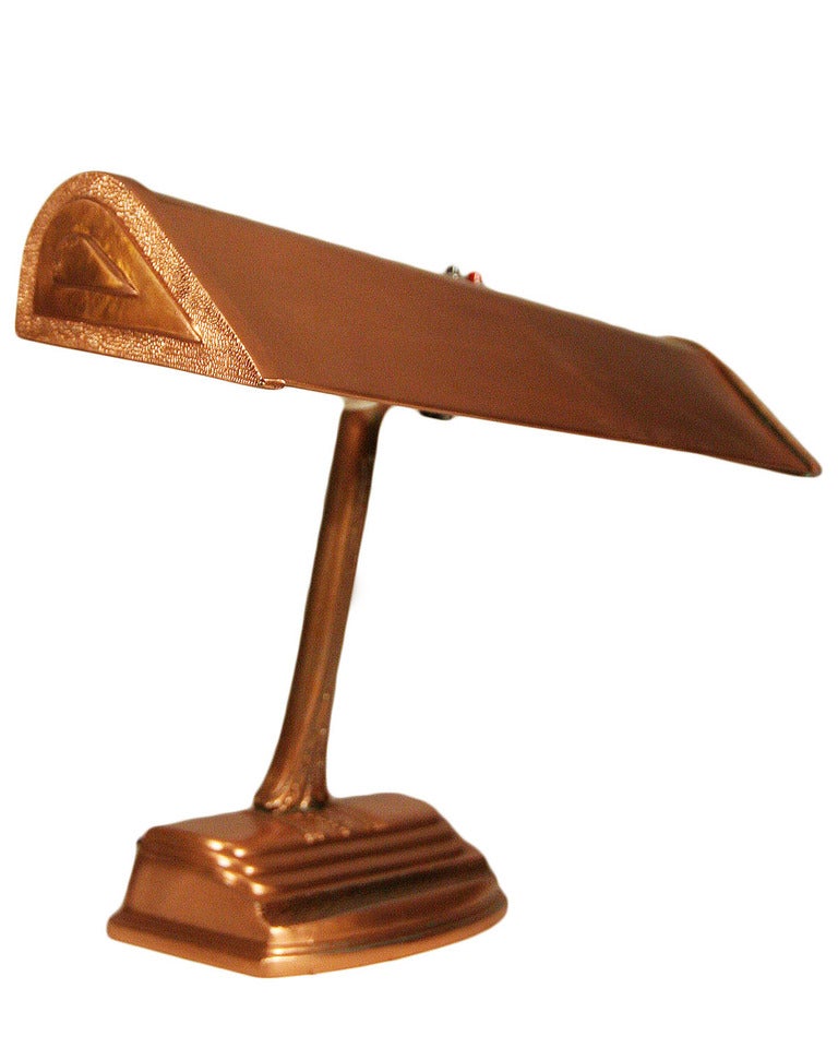 This elegant and functional Art Deco desk lamp is rendered in polished copper and features elegant detailing such as the stepped base and the pebbled finish which appears in sections throughout.
The lamp allows for two fluorescent bulbs and retains