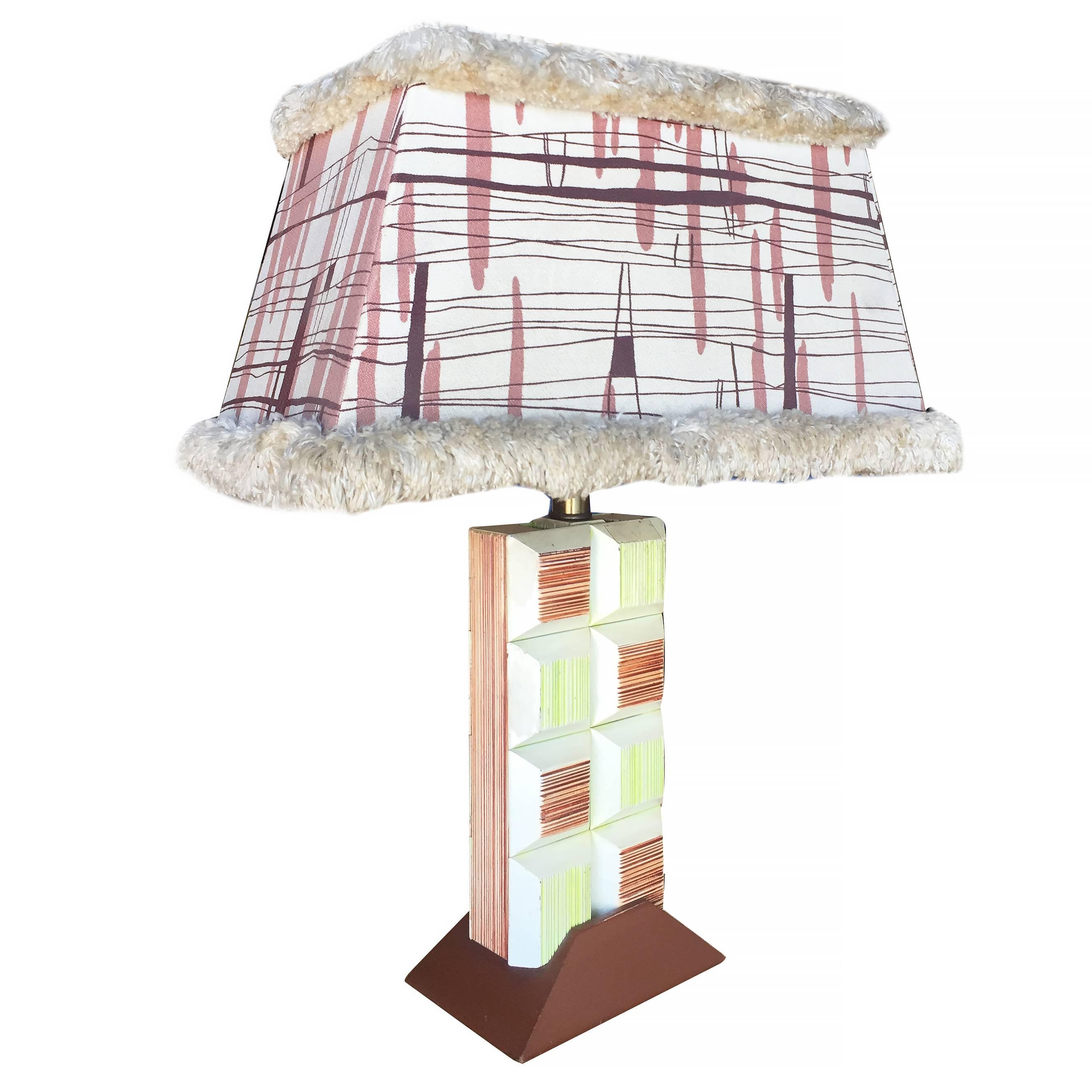 Midcentury era Paul Frankl inspired combed cubist block lamp pair featuring a hand painted stacked block design with a triangular base and original lamp shades.