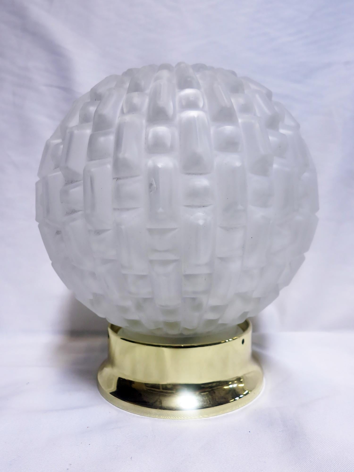 This unique and exquisite French Art Deco sculptural glass globe features a high relief geometric pattern with symmetrical lines and angles distinctive throughout the Deco period. Available with a new brass or chrome 4
