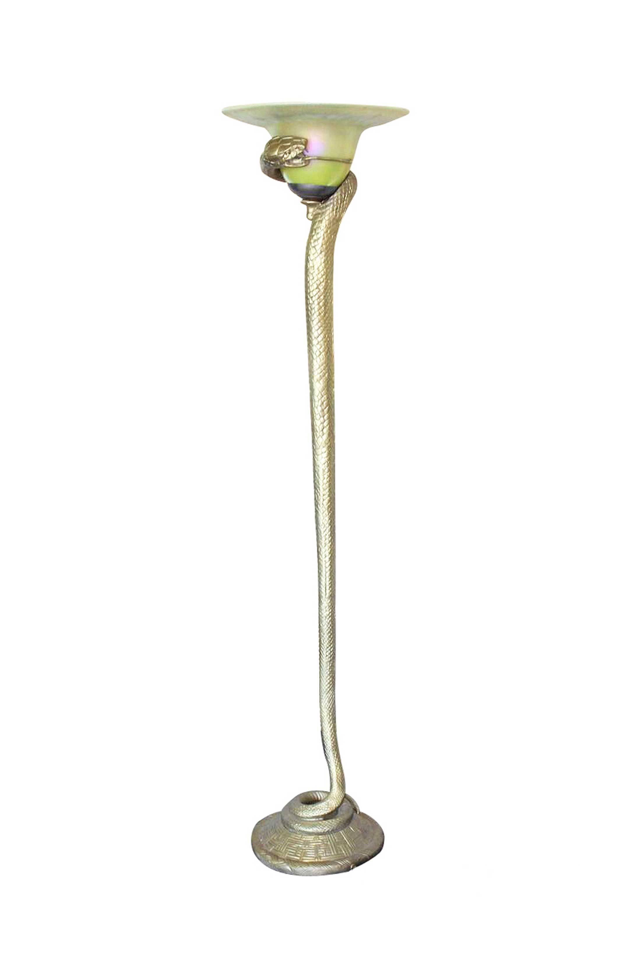 Stylized after the original snake lamp by Edgar Brandt, this lamp is made of custom hand cast bronze. The piece shows a highly detailed snake, coiled around a light shade with its open mouth exposing its fangs and forked tongue. The marvelous snake