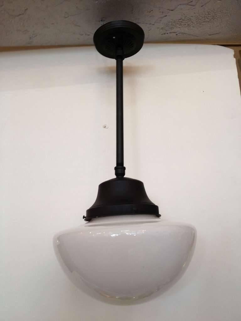 Circa 1920 painted black pole and fitter with schoolhouse milk glass  globe.pendant 

Light Fixture- 30