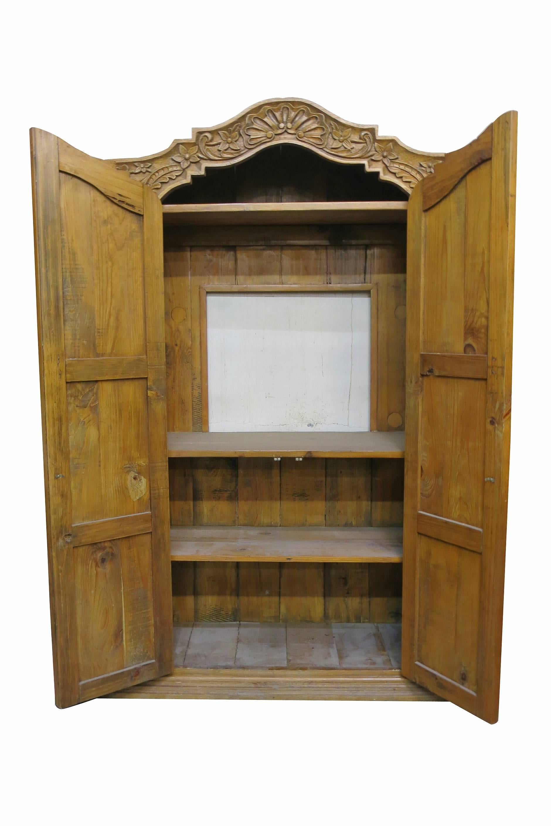 Beautiful hand carved wardrobe TV cabinet made from repurposed antique wood. This Cabinet opens with a middle TV Shelf with an additional top shelf for a Roku/DVD/Cable Box and two bottom selves for storage or additional components.  