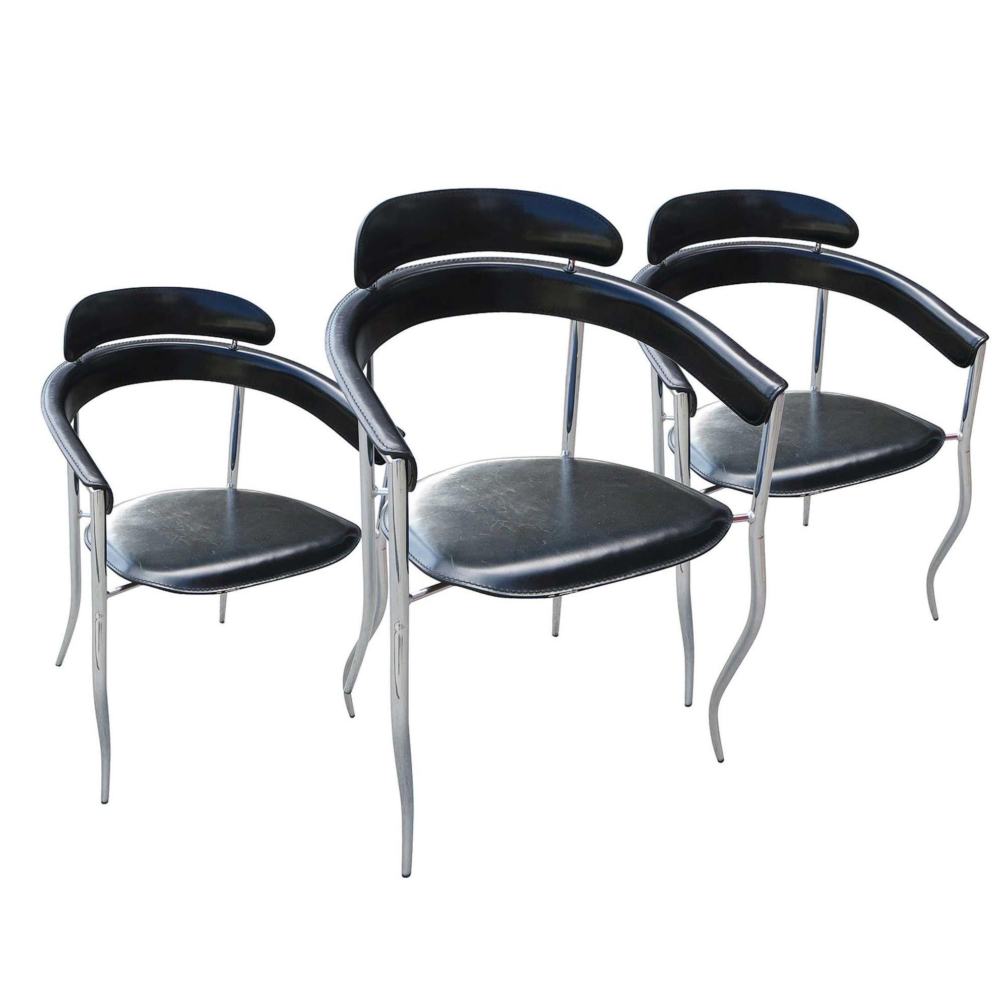 Set of four Italian Stiletto dining armchairs manufactured by Arrben furniture. These four chairs tiptoe on chrome frames supporting black leather seating, backrest, and armrests.
 
Like most stilettos, these are not made for walking but steal the