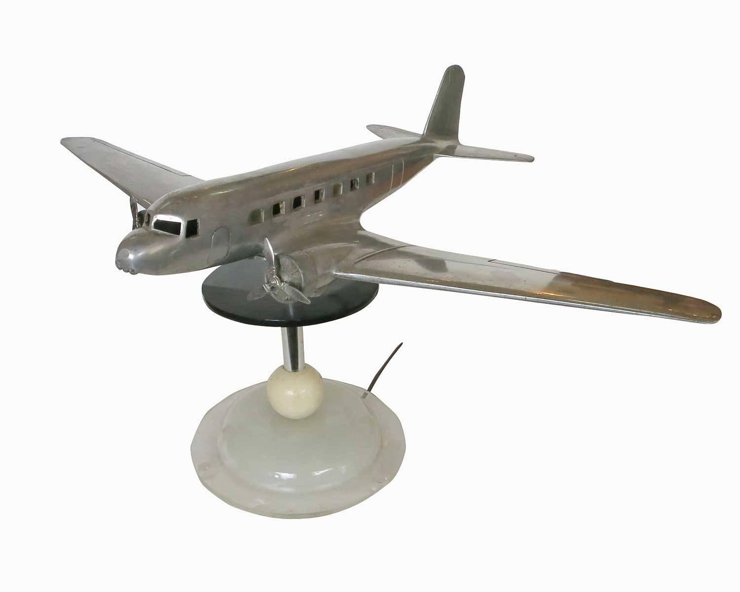 Rare polished aluminum lamp model created for Douglas Aircraft and TWA in 1934 by the Victor F. Patushin Company. The model is constructed of a solid single piece aluminum body with a bottom plate for changing light bulbs and fixing it to the