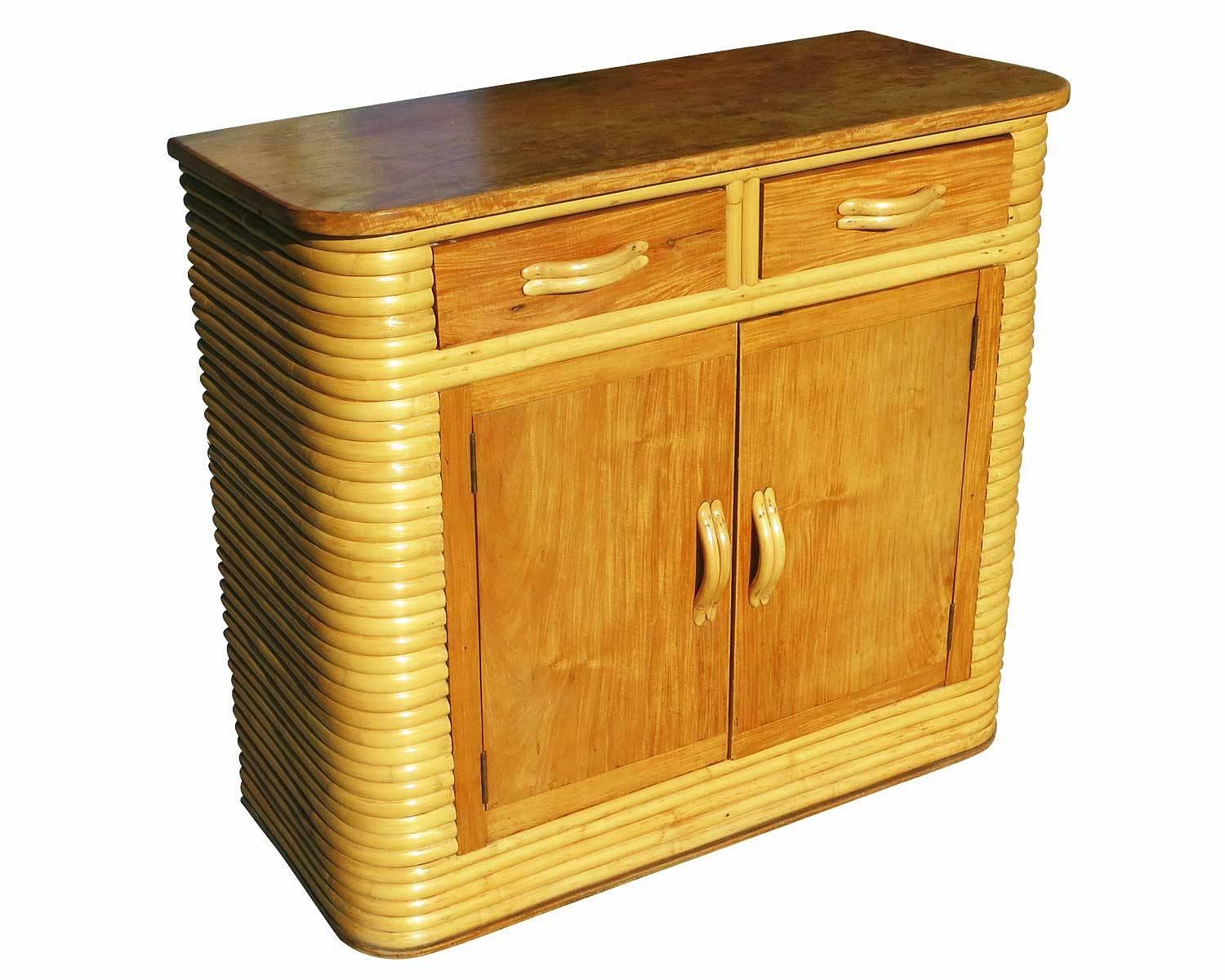 Stacked rattan storage cabinet with a mahogany top and rattan drawer pulls by Valdes Rattancraft. The cabinet features breakfront storage area in the front with two drawers.

Tag states "Steam Treated Valdes Rattancraft Inc.Made in The