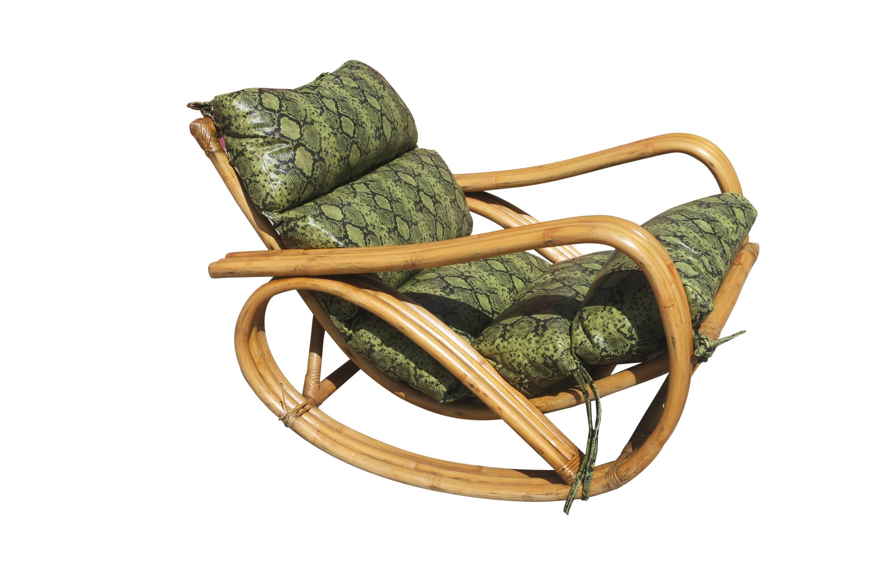 A rare Paul Frankl inspired three-strand pretzel arm rattan rocking chair with Faux Snakeskin cushions. This chair features a steam bent rattan frame.

Two available, circa 1940.

Chair: 27