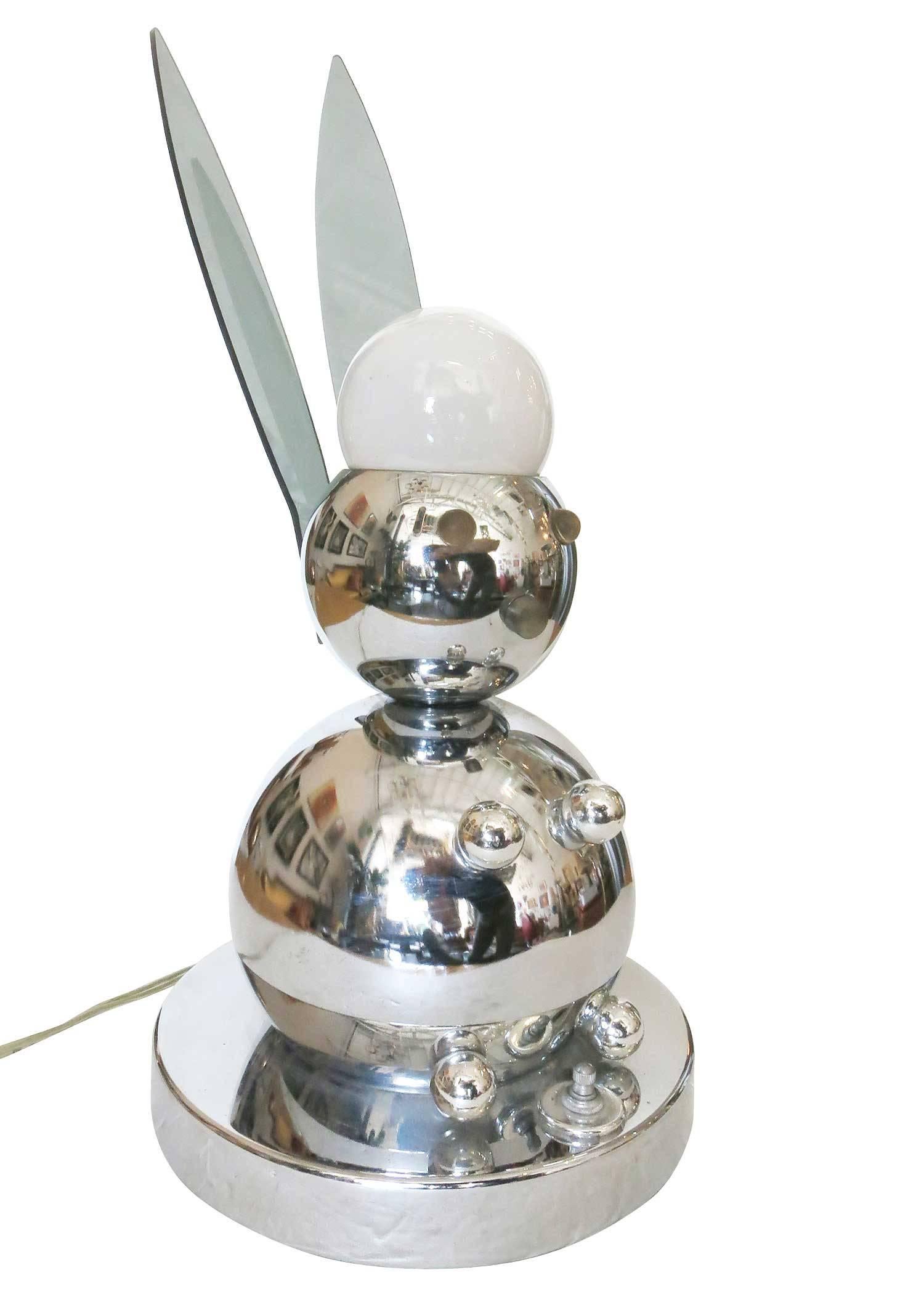 Postmodern chrome bunny rabbit lamp constructed entirely of chromed steel and Lucite accent pieces. The rabbit is made of a series of different sized chromed balls with Lucite ears and light up eyes which sit on a chrome base.