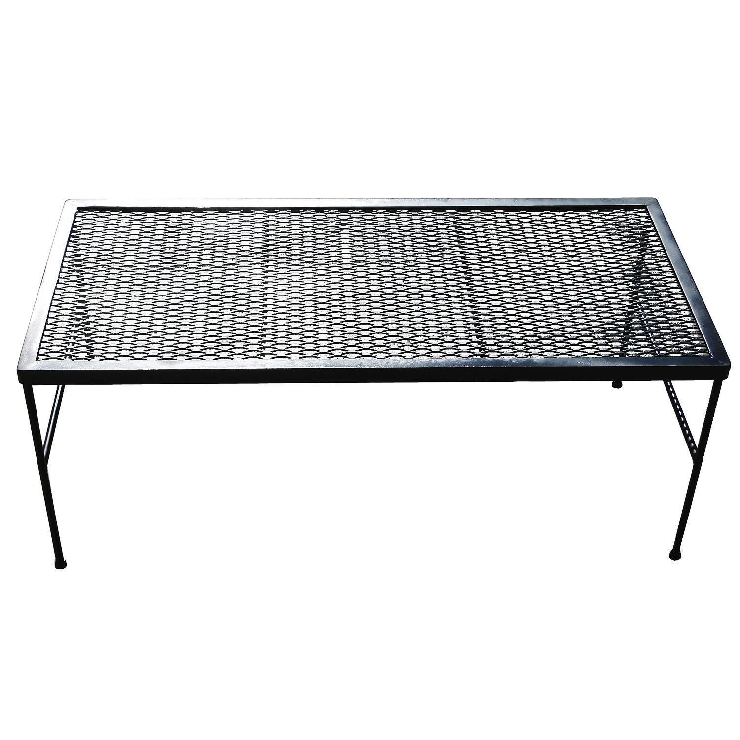 Vintage outdoor patio coffee table with iron base and steel mesh top by the Woodward company. Table has been repainted in black but can be repainted in your choice of color.
USA by Woodard, circa 1950.
 