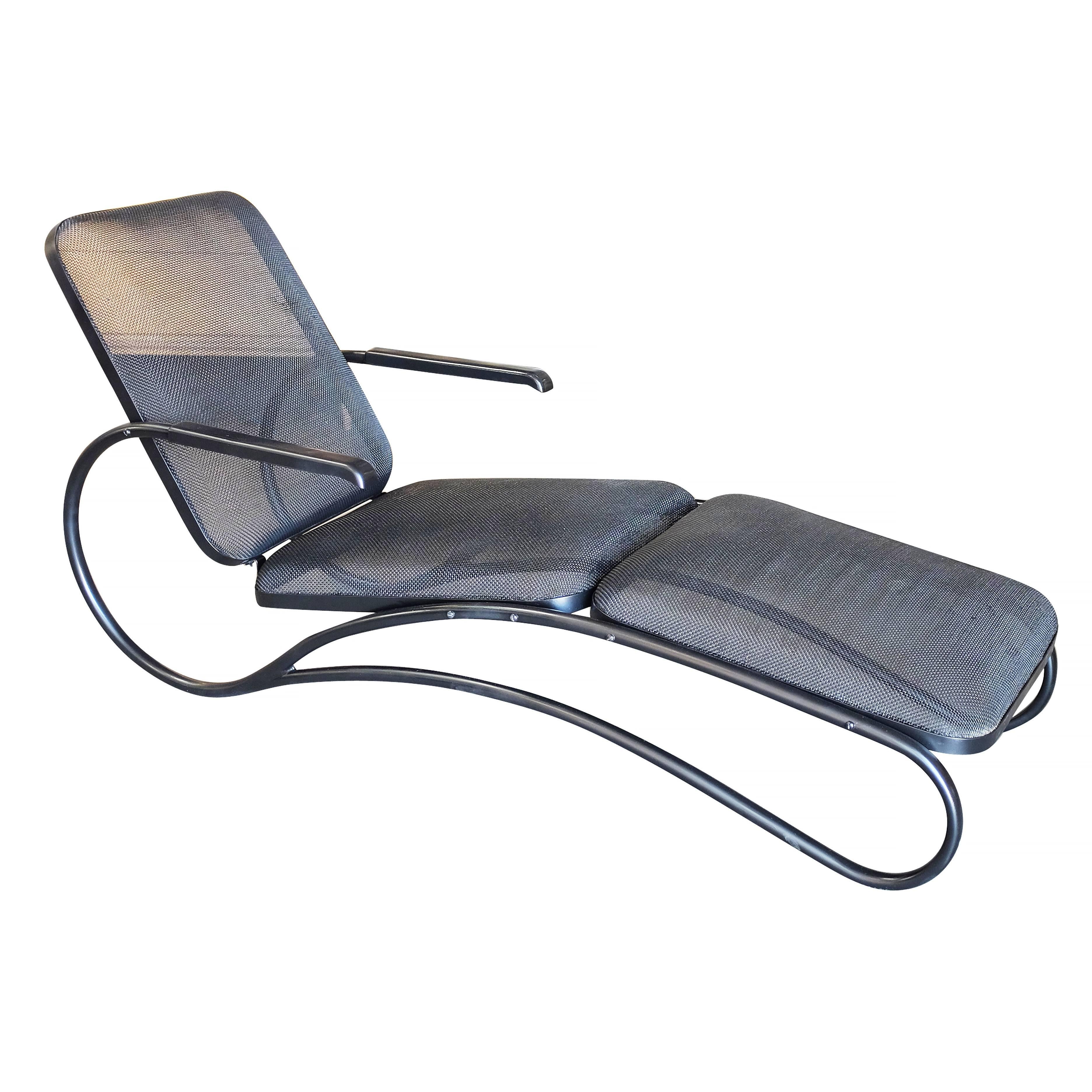 Rare midcentury spring mesh outdoor/patio chaise longue with spring mesh seat and flowing sculptural tubular arms.